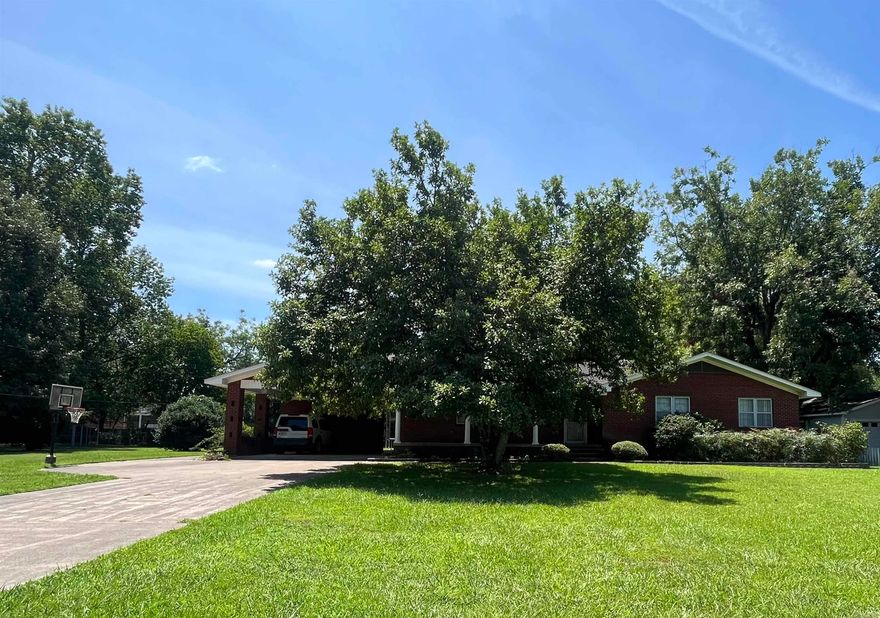 Enjoy living in this delightful 3 bedroom 2 bath home boasting over 2000 square ft.  This home boasts beautiful hardwood floors, tons of storage and plenty of space for outdoor living as well on this oversized lot.  Take advantage of the large, covered patio, 2 car covered parking, nice shop and ample amount of outside storage. This home also features a small basement that could be perfect as a storm shelter or additional storage space. Get your private tour scheduled today!