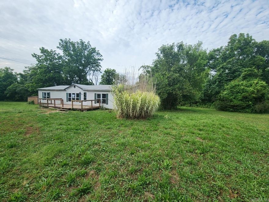 Manufactured home on edge of town with secluded setting on 1 AC M/L. On permanent foundation. Carpeting has even been pulled out. 3 bedroom, 2 bath, nice floor plan. Mostly level. 1680 SQ FT $89,900