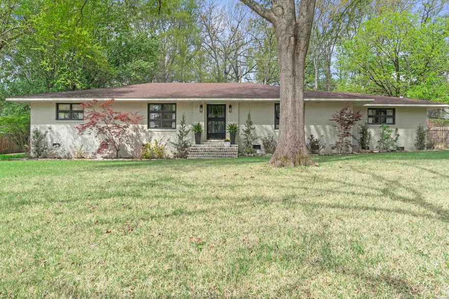 Stunning new listing with exceptional curb appeal, perfectly situated on a private lot on Shannon Drive. This beautifully updated, move-in ready home is a must-see. From the moment you arrive, you’ll notice the lush sodded yard, mature landscaping, and fresh cream brick exterior highlighting its timeless mid-century style.  Inside, a spacious layout offers two inviting living areas, one with a cozy fireplace, plus an eat-in kitchen featuring updated cabinetry, an island, stainless steel appliances, and gorgeous stone countertops. A unique corridor with ample storage connects the spaces, while formal living and dining areas complement the open-concept kitchen and family room.  The split floor plan provides a private primary suite with a full bath and walk-in closet. Two guest bedrooms on the opposite side each offer en-suite baths. A convenient laundry/mudroom adds function.  Enjoy a private fenced backyard with patio and pergola—perfect for relaxing or entertaining. Recent updates include roof, flooring, kitchen, and more!