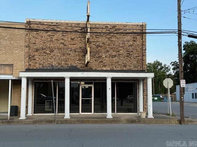 This brick building is perfectly situated in a prime location, making it ideal for your business needs. The large display window at the front offers excellent visibility, while the office space inside ensures functionality. Upstairs, there's a spacious second story that can be used for storage or as an additional room, complete with a bathroom and shower for convenience.