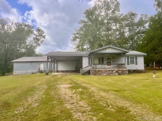 Looking to be near Lake Ouachita? You have found it, and it's only 8 minutes to waters edge. In this great country setting is a 2 bedroom, 1 bath home w/ acreage that has been well kept. Many updates over the years. In additional is a 40x40 garage, 12x16 storage building, covered boat shed, and so much more. Seller is offering a $5,000 carpet allowance. This property is a must see.