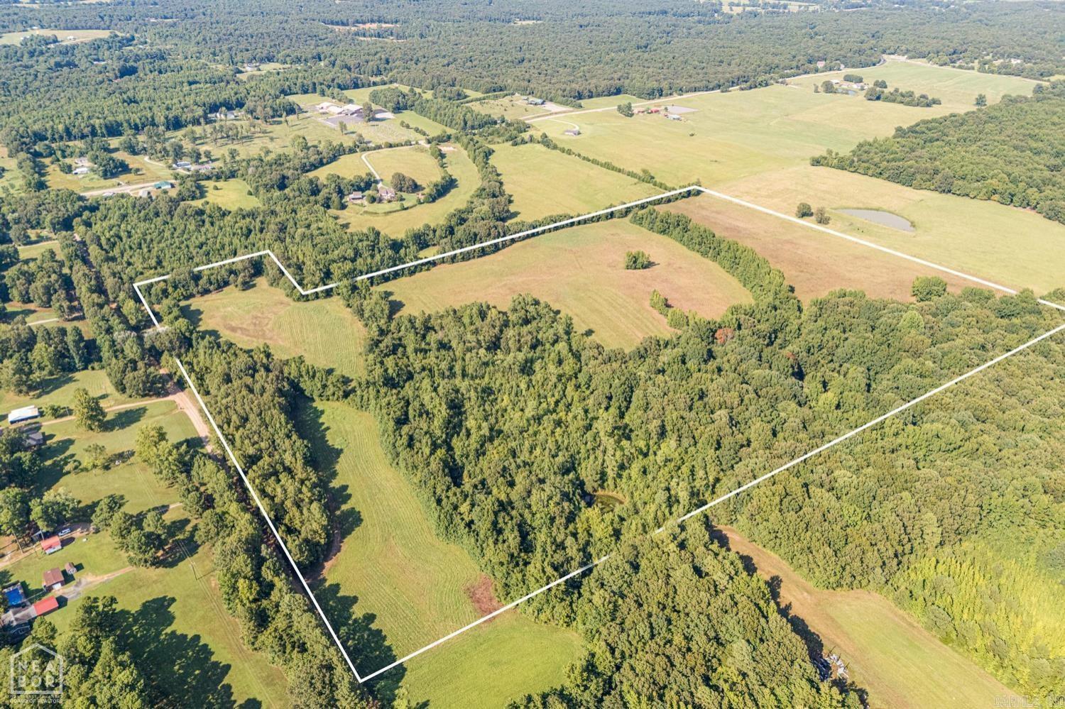 RARE FIND! Absolutely gorgeous 62 acre (+/-) parcel with wooded areas, cleared areas, and a small pond. There are no restrictions so the possible uses are endless. Build your dream home in the woods and never see a soul, or establish that farm you have always dreamed of. Heck, with this much land, you could hunt off your back porch and harvest all the deer and turkey you want. Lots of road frontage means that establishing a family compound would be so easy. Far enough in the country that you would have privacy but yet close enough to be able to be in Jonesboro or Paragould within minutes.