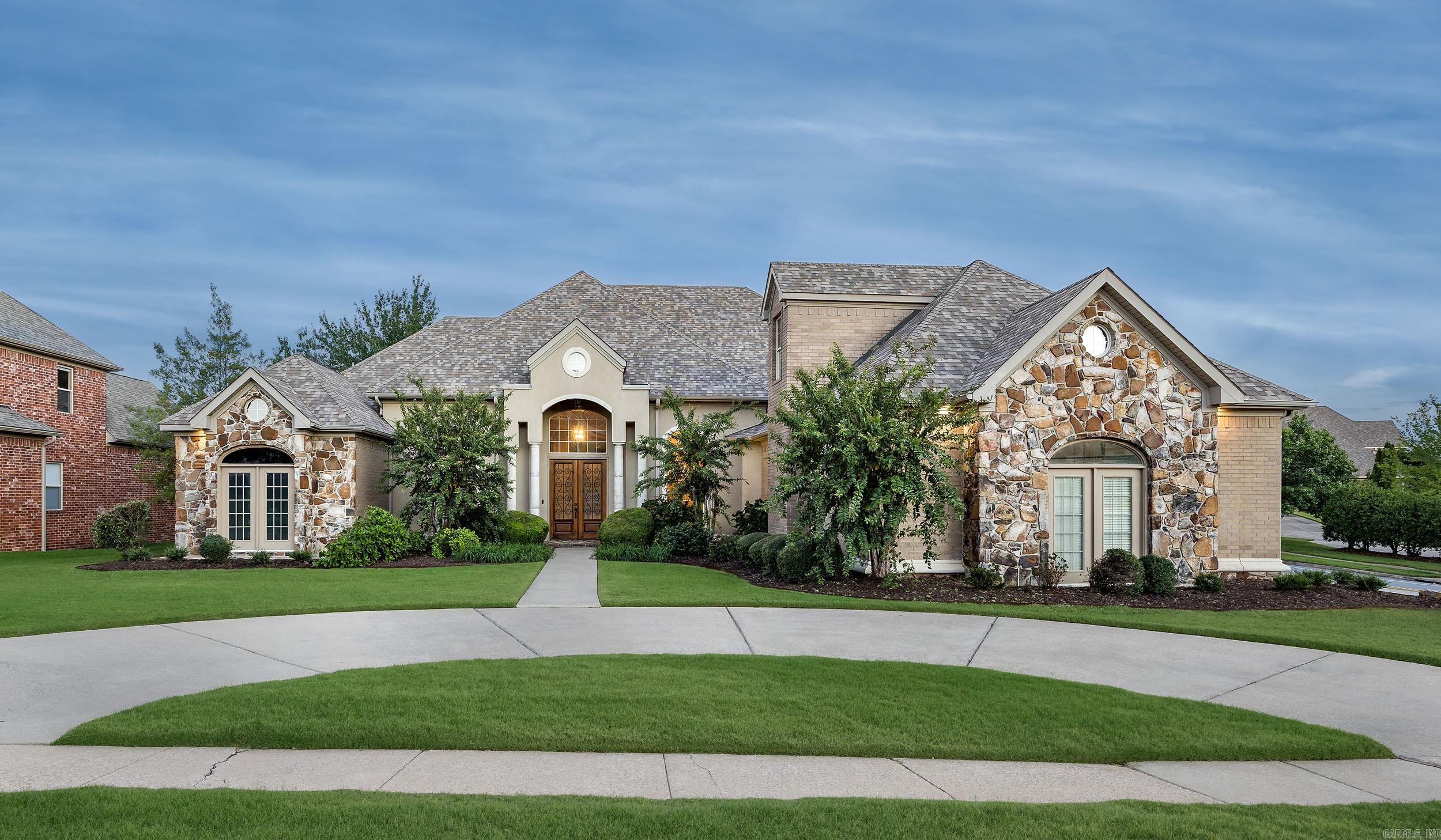 Stunning custom-built home in the highly sought-after Villages at Wellington! 4BR, 3.5BA on a flat corner lot with circle drive and 3-car side-entry garage. Open floor plan with hardwoods throughout—no carpet! Grand 14’ ceilings, two fireplaces, and an exposed brick kitchen with massive granite island, gas range, and abundant storage. Luxurious primary suite with private HVAC, floor-to-ceiling windows, spa bath featuring double shower heads, Jacuzzi tub, built-ins, and French doors leading to the covered patio. Two additional bedrooms down, plus office with built-ins. Upstairs offers 4th BR, full bath, and large game room—ideal for in-law quarters! Massive covered patio with hot tub and direct gas line for grill. Fully fenced yard with rod iron fencing. New roof (2020) and three new HVACs (2024). Walk to pool, playground, and tennis/pickleball courts. Perfect one-level living and an entertainer’s dream! Agent see remarks.