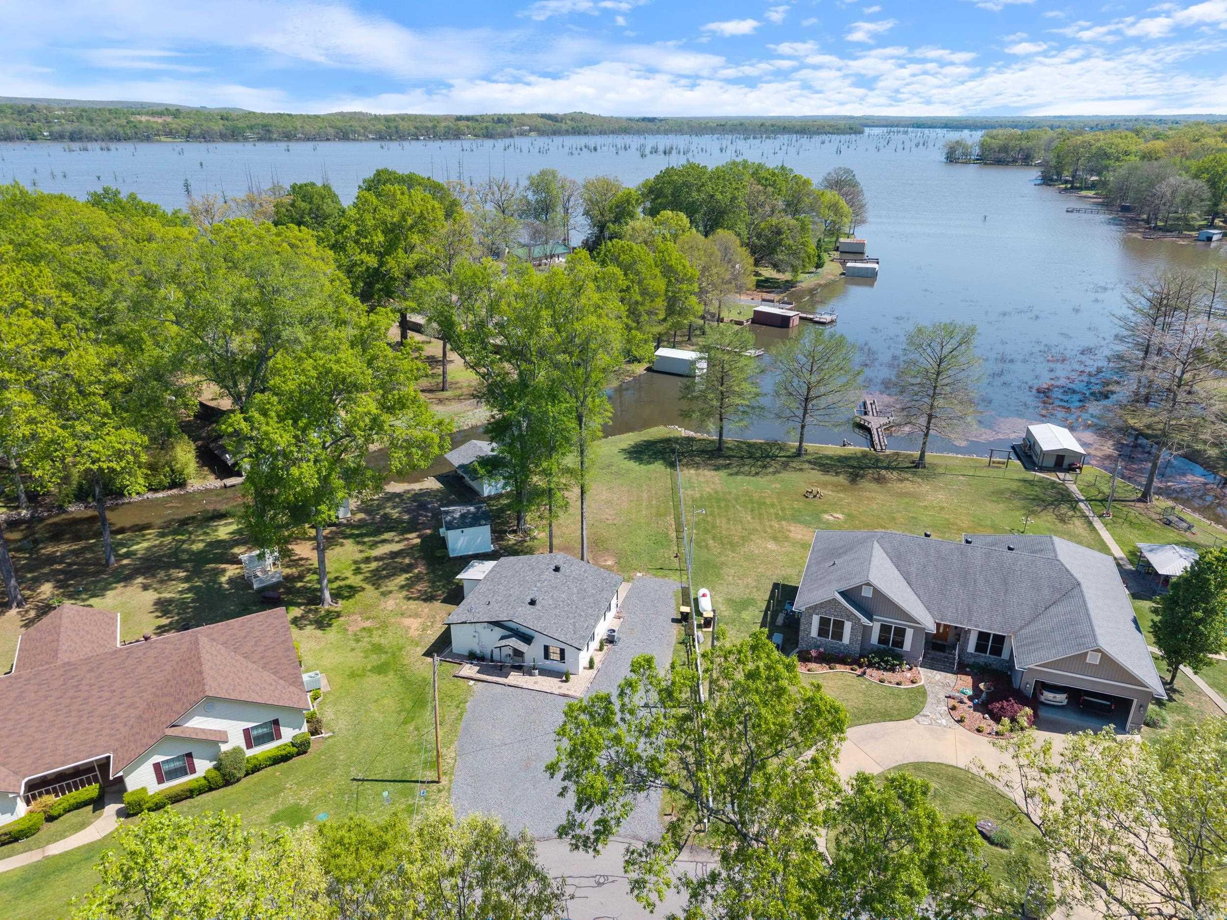 Lake Conway stunner! You will be hard pressed to find such an amazing lake front home at this price anywhere in Arkansas. Beautifully remodeled 2 bed/1 bath lake front home with boathouse, shop, and incredible views. Imagine waking up, taking in your morning coffee on the back patio, then paddling or boating out on Lake Conway at sunrise for world-class fishing. Lake is currently drained and only fills up after heavy rains. The Game and Fish Commission is restoring the lake and working on the dam as part of the Lake Conway Restoration Project. When complete, Lake Conway will be better than ever. The home features an open floor plan with all new kitchen, beautiful views out to the lake, and 2 bedrooms with one bathroom. No wasted space in this home. Beautiful mature shade trees create a park-like setting in the back yard. Roof is only 3 years old, which helps with insurance costs. More updates include HVAC with i-wave (2022), new electrical service (2022), water heater (2023), new appliances (2023), Remodeled kitchen (cabinets, countertops), remodeled bathroom, 50A outlet for car charging/RV, gutters with leaf guards and French drain. Easy access to Little Rock and Conway via I-40