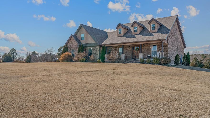 Welcome to your own slice of peaceful country living on 1.61 acres, where space, comfort, and beautiful views come together perfectly. From the moment you pull up the drive and step onto the welcoming front porch, this home just feels inviting. Inside, you’ll love the open layout centered around a stunning stone fireplace with custom built-ins—creating a cozy focal point for everyday living and gatherings. The kitchen offers abundant cabinetry, stainless appliances, generous counter space, and a large breakfast bar that makes hosting or busy mornings easy. The spacious primary suite is a true retreat with tray ceilings, great natural light, and a spa-like bath featuring double vanities, a tiled walk-in shower, and a relaxing jetted tub. Even better, the oversized primary closet doubles as a storm shelter for added peace of mind. Upstairs, the bonus room includes a dedicated office area, giving you flexible space for working from home, a second living area, playroom, or whatever fits your lifestyle best. Step outside and take in the wide-open surroundings, covered patio, and expansive yard with room to spread out, play, or simply enjoy the quiet setting with outdoor storage.