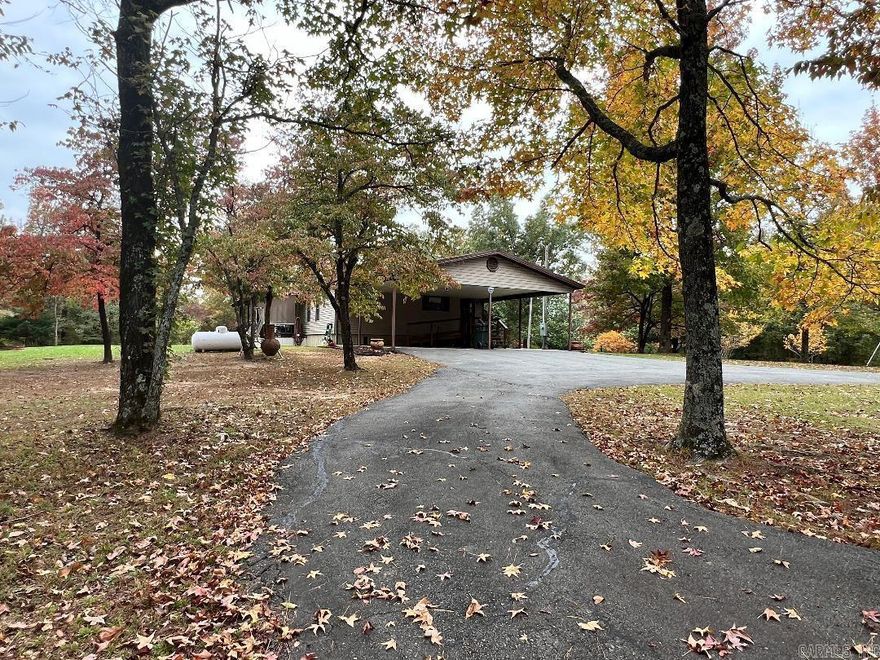 WOW!!! This tranquil setting is showing all of its Fall color! Amazing and breathtaking are an understatement. This meticulously maintained home has 3 bedrooms, 2 bathrooms, breakfast room, built ins, open concept, metal roof, newer siding, 2 car concrete carport with wheelchair ramp, new energy efficient mini splits as well as central HVAC, a separate space for MIL home with sewer, water and electric and carport, 2 storage sheds and a paved circle drive! It truly is stunning! The kitchen has plenty of space for cooking and prepping with an island and built in buffet in the breakfast nook.  But why stay inside when you have this amazing yard with beautiful landscaping? Sit on the back covered porch and relax while sipping coffee. This one is a MUST SEE! Agents see remarks for additional information for your buyers Pre-approval required for showings 24 hr notice