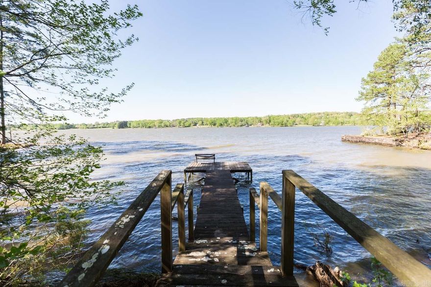 This lakefront property isn't just a house, it's a gateway to a life less ordinary.  Spend your days basking on the dock, swimming in the cool water or exploring the hidden coves.  Launch your boat from your private dock because this lake is perfect for water skiers and jet skiers of all levels. With this property being nestled in the woods, evenings can be filled with marshmallow roasting over a fire pit.  Another bonus is the over 700 square feet guest house, which has a full kitchen, living, laundry, bathroom and bedroom that's perfect for friends or family.  This is the place to connect with nature, but also have the convenience of town minutes away! See Agent Remarks