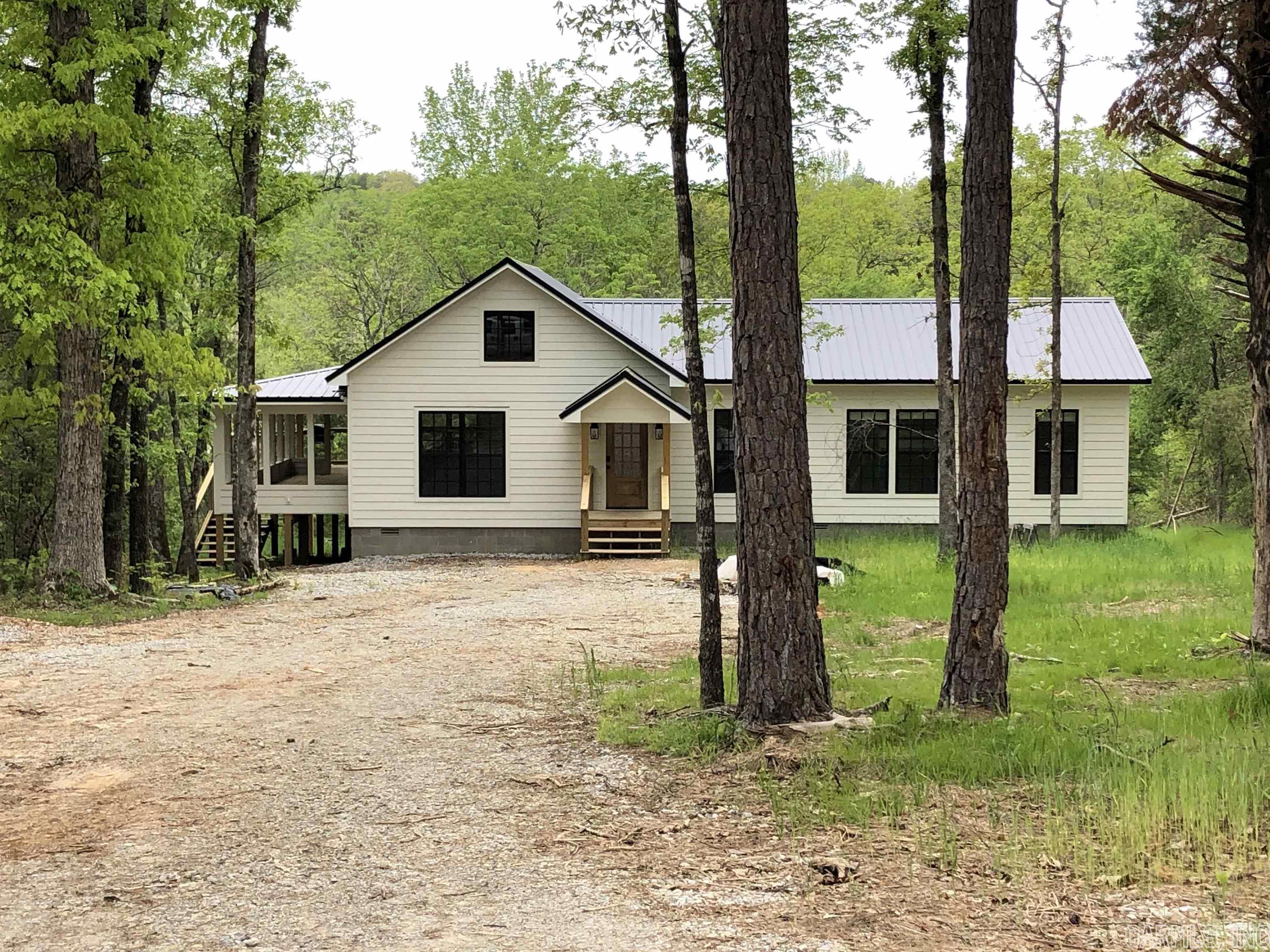 Piney Creek!! Absolutely Beautifully finished house on Piney Creek. Approximately 300 Ft. of Piney Creek Frontage. This is the perfect getaway from the Rat race. Nestled in the trees with great views of Piney creek and a short trail to the water where you can dip your ties in the creek and watch the Kids splash and play in the water. Vaulted ceilings in the Living Rm and Kitchen and 9 Ft ceilings throughout the rest of the house. White washed shiplap walls with dark wood stained beams and chandeliers that give a luxurious but rustic feel. The Master suite is all about relaxation. Enjoy setting out on approx. 600 sq. ft. of deck enjoying the sound of the creek and cooking out with friends and family. The house has Foam insulation and is set up for a Generator. This property is Ready to enjoy today.