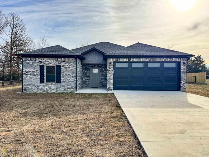 Beautiful brick home on oversized 1/2-acre lot in Quitman. This neighborhood is small and quiet, and kids could easily walk to Quitman Schools. The entire back yard is fenced - privacy fence next to the neighbor and chain link elsewhere so you still get the view of the field. Covered back porch to sit and watch the kiddos or dogs run. As you enter the front door, there's a coat closet to the right. The entryway opens to the living room, which has vaulted ceilings and recessed lighting. The kitchen has quartz countertops and a great pantry, as well as good storage in the island, which easily seats two. Behind the island is a large area that can be used for a dining room, office, or play area. Durable luxury vinyl plank flooring throughout.  Split floor plan with master suite apart. There is a huge walk-in closet attached to the master bathroom. The second and third bedrooms both have nice closets with built-ins. Sizable laundry room with wall cabinets, built-in folding table, and large closet with shelves. The two-car garage even has an outlet for an electric car charger. Great location, not even a mile from town and super easy access to Hwy 25 for travel to Conway or Little Rock.