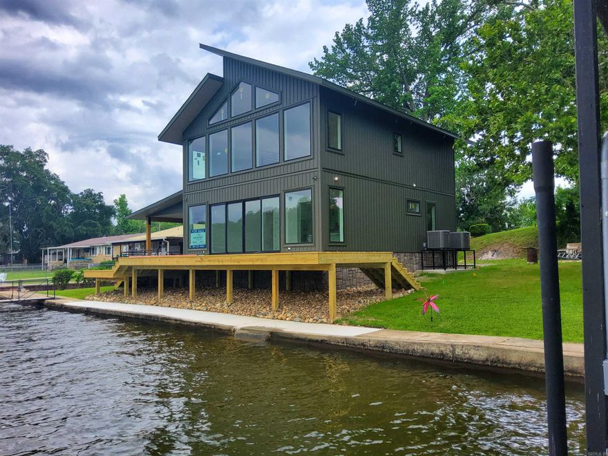 Lakefront living at its best is almost complete in this beautifully crafted home featuring upscale finishes and spacious designs.  Your private launching ramp is rare.   The huge covered patio and deck are perfect for relaxing and entertaining.  Upper loft area will give endless options of living space.  Professional pictures will be taken after construction is completed.
