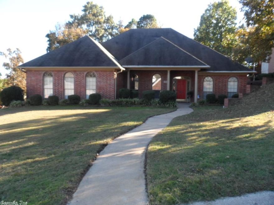 Charming street appeal in an established convenient neighborhood. Split BR plan with 3 on the main level & an oversized BR with sitting area & private bath upstairs. The side-load garage gives the home a clean country French appeal from the street view. Brick exterior, a column supported front porch and 7 arched windows grace the front with a curved sidewalk leading from street parking to the front door. The kitchen is updated with large limestone porcelain tiles and granite countertops. Wood in Greatroom