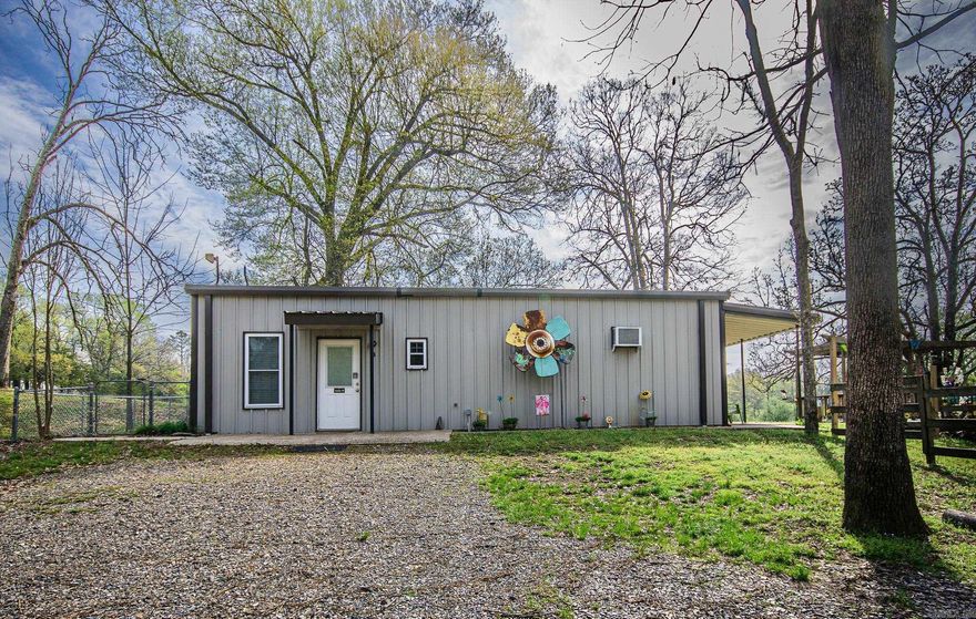 This 3-acre creek side property is a fully furnished, turnkey short-term rental with two separate suites, offering a fantastic opportunity for both investment and enjoyment. The first unit is a spacious studio with a king-size bed, a cozy living area, eat-in kitchen, full bathroom, and shared utility room access. The second unit is a one-bedroom, one-bath, separate living room, eat-in kitchen, private back porch, and also shares the utility room. Outdoors, enjoy a large back patio area with a pergola, a fire pit for relaxing evenings, and a storage shed for added convenience. A highlight of the property is the year-round creek - perfect for peaceful moments in nature just steps away. Additionally, the property has a 30-amp RV hookup and offers a perfect spot at the front of the property to build your dream home, allowing you to create your perfect space while generating income from the existing rentals. Included with the sale are all furnishings, both indoor and outdoor, along with kayaks and patio furniture—everything needed to start hosting guests or enjoying the space yourself from day one.  Please see agent remarks for showing instructions.