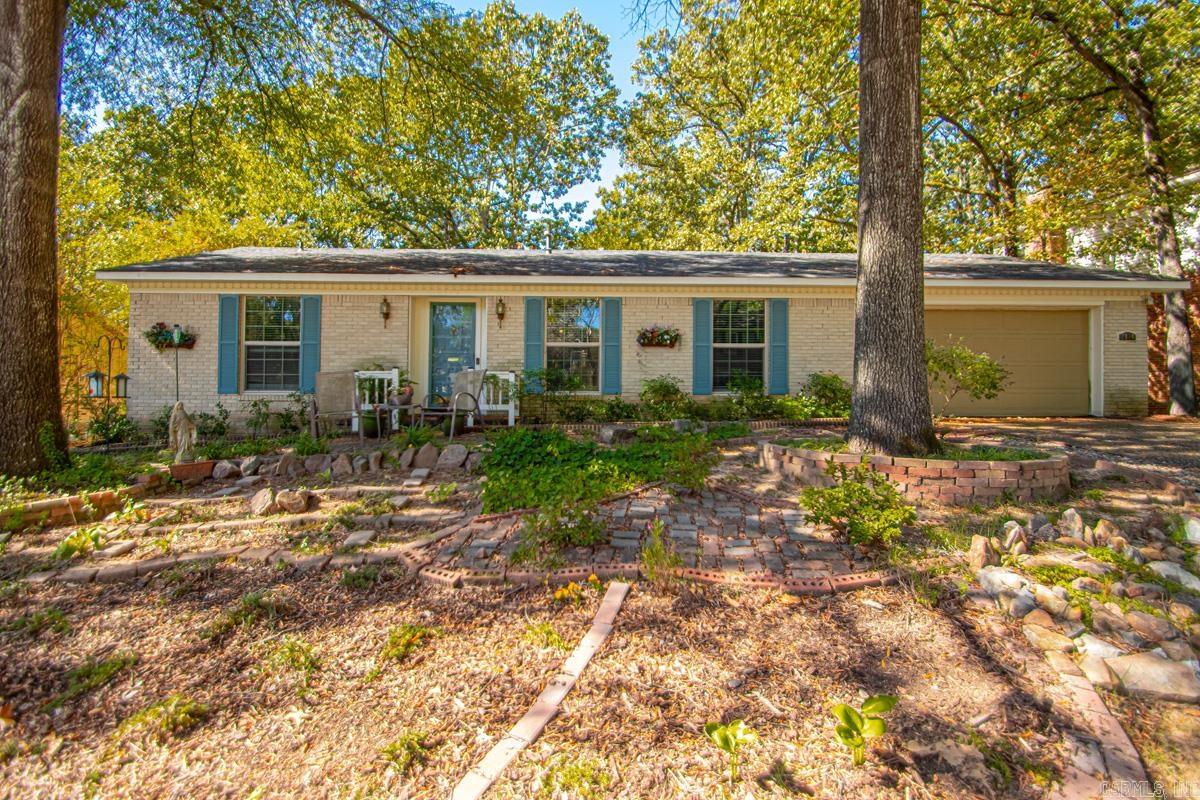 Welcome to this inviting 3BD/2BA + office (currently used as craft room) brick home with perfect blend of comfort & style - all on one level on gorgeous, tree-shaded lot! Step inside to discover LVP flooring (2023), creating a fresh, modern feel. Carpet adds comfort & coziness. Spacious den features classic brick FP offering warmth & character at the heart of the home. Den opens to the formal living/dining, & Pella windows (2018) fill the home with natural light while enhancing energy efficiency/comfort. Stove & microwave (2022), DW (2024), stylish tile backsplash, lighted display openings, custom-designed pantry cabinets with built-in drawers. Spacious laundry featuring built-in cabinets/utility sink. Outside, enjoy serenity of screened-in covered deck overlooking mature trees & low-maintenance rock flower beds. This is the perfect extended living space to relax & enjoy the outdoors. Roof (2018) offers peace of mind for years to come, well insulated & bountiful garage shelving. Home offers timeless brick construction, thoughtful updates & tranquil surroundings including renovated neighborhood pool/courts/playground just block away, making it a special place to call home! Come See!