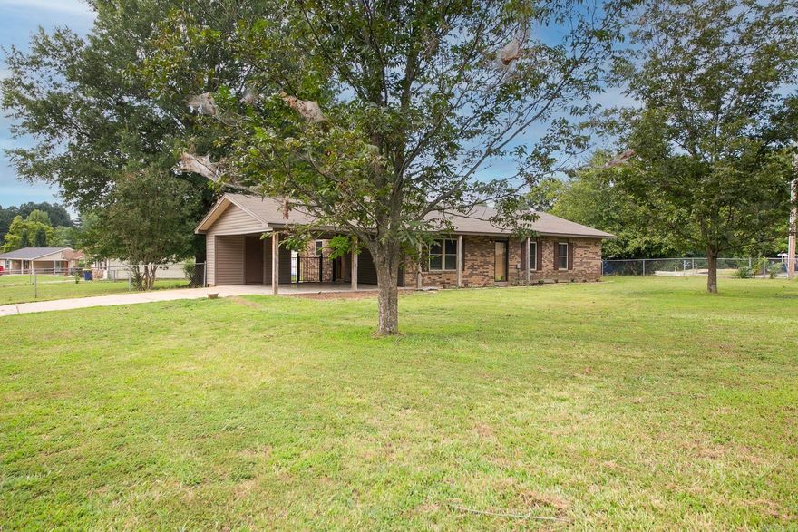 Super cute home sits on two lots (almost an acre) with large rooms and a ton of updates.  The cook of the family will love the large udpated kitchen with granite counter tops, stainless steel appliances (fridge stays too), and a pantry closet.   Cozy up to the woodburning fireplace on those cold winter days...great place to hang Christmas stockings too!  You will love the spacious bedrooms and the newly remodeled bathroom.  Updattes include new roof in 2021, new hotwater heater- 2024, hardwood flooring & tile, windows, interior doors & hardware, siding with a lifetime warranty, bathroom remodel.  Plenty of room for kids to play in the supersized fenced in backyard...even has an outbuilding for storage.  Call to see this one today.