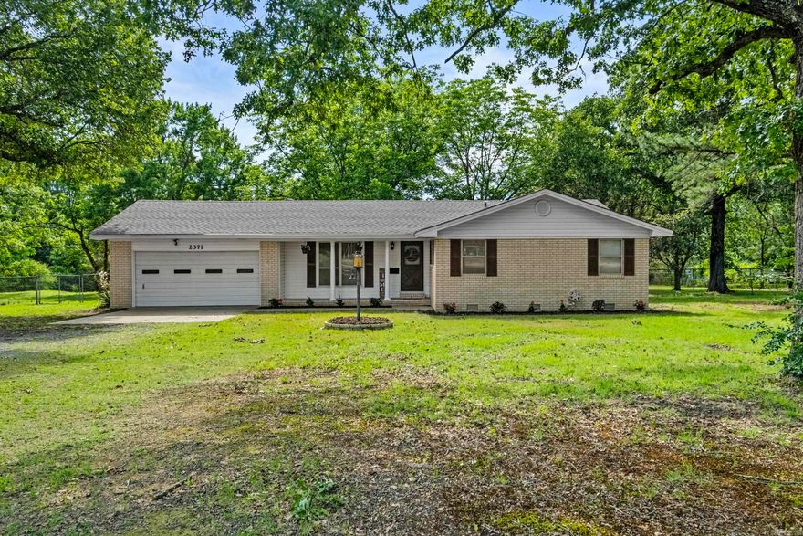 3 bedroom, 2 bathroom brick home located just outside Searcy city limits on nearly 2 acres with generous highway frontage, offering excellent visibility and potential for both residential and commercial use. Features include a large dining room, office, oversized updated garage with storage area, and a covered back porch overlooking the fully fenced backyard. Recent 2026 updates include a new roof, soffit, decking, paint, landscaping, and new interior and exterior metal and door on the shop. Additional features include 50-amp service, a storm shelter conveniently located just off the back patio, and additional septic system in the backyard where a former mobile home was previously located. Seller believes tax records are inaccurate; square footage is based on seller measurements.