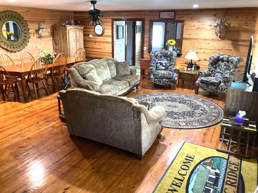 Beautiful Vacation Rental home in the heart of Historic Hardy Arkansas! This is a must see!!! This 2000 heated sqft Spacious 4 bed 3 bath single story home is walk in ready, just 1 block from the shops of Historic Main St Hardy and only 3 blocks from the scenic Spring River, Location is the key to this beautiful home. Home features roomy living space, Knotty Pine floors and walls, and the warm & cozy ambiance of a country lodge. Drink coffee on the full-length front porch or host a cookout in the attached open-air pavilion!  It is currently being used as a vacation rental but would also make a great home for someone looking to be close to town or as an investment property with immediate income. A second water heater, and new Architectural shingle roof, and new HVAC are just a few of the recent updates. Motivated Seller! Agents bring all offers from qualified buyers!!!