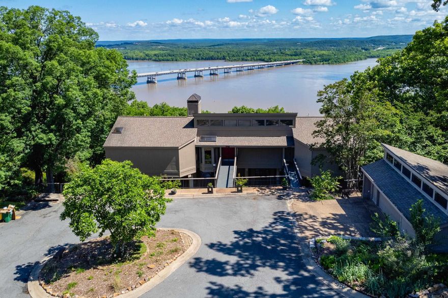 Luxury River View Retreat in River Ridge! Discover your dream home nestled on 6.85 serene acres with breathtaking river views. This stunning property offers a perfect blend of elegance, comfort & outdoor living. Key features include a spacious primary suite and guest suite on the main level, private mother-in-law or guest suite with its own exterior entrance, complete with kitchenette and full bath. 14 x 48 (4.5' deep) lap pool with new decking, perfect for relaxing and entertaining. Elevator servicing all three levels for convenience and accessibility. Two car detached garage. Custom wood and steel decking on two levels. Whether you're seeking a peaceful retreat or a place to host friends and family, this exceptional property offers it all. Don't miss out on this unique opportunity-schedule your private tour today! Home built by Jack Hartsell. Third bedroom is in the apartment.  See Showing Remarks, Agent Remarks and Attached Documents for more information regarding this unique property.
