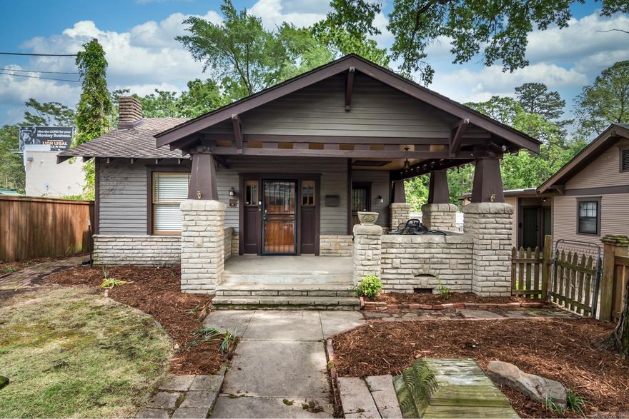 Charming bungalow in the desirable Capitol View neighborhood! This quintessential 2-bedroom, 2-bath home also offers a versatile bonus room that can serve as a third bedroom with an ensuite bath, perfect for guests or a home office. The light-filled living space features original hardwood flooring throughout, exuding timeless elegance. The remodeled kitchen is a delight, featuring an abundance of cabinet space and updated appliances, including a new refrigerator (2017) and gas range (2024). Enjoy the convenience of a separate laundry room for added functionality. Relax on the inviting wrap-around front porch, a perfect spot for morning coffee or evening sunsets. Updates include new HVAC installed in 2020, all interior painted in 2022, and a new sewer line to the main. This property is ideally located close to UAMS/St. Vincent, downtown, and the airport, making commuting a breeze. Additional features include a one-car carport and an assumable VA loan for qualified buyers. Don't miss this opportunity to own a piece of Capitol View charm.