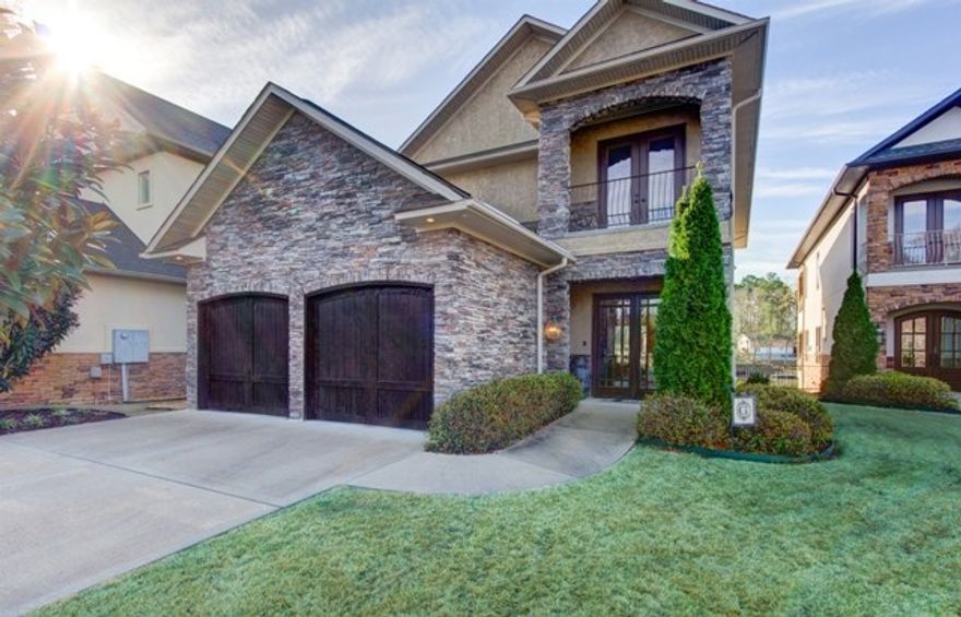 Luxury lake living awaits you! This gorgeous home features 3 levels of upscale finishes, an elevator, custom wall treatments, granite throughout, a relaxing lakeside patio, 2 birds eye view decks with outside kitchen perfect for entertaining, a gourmet kitchen and 2 living areas. This dream home can be your reality! Most of the furnishings to convey!