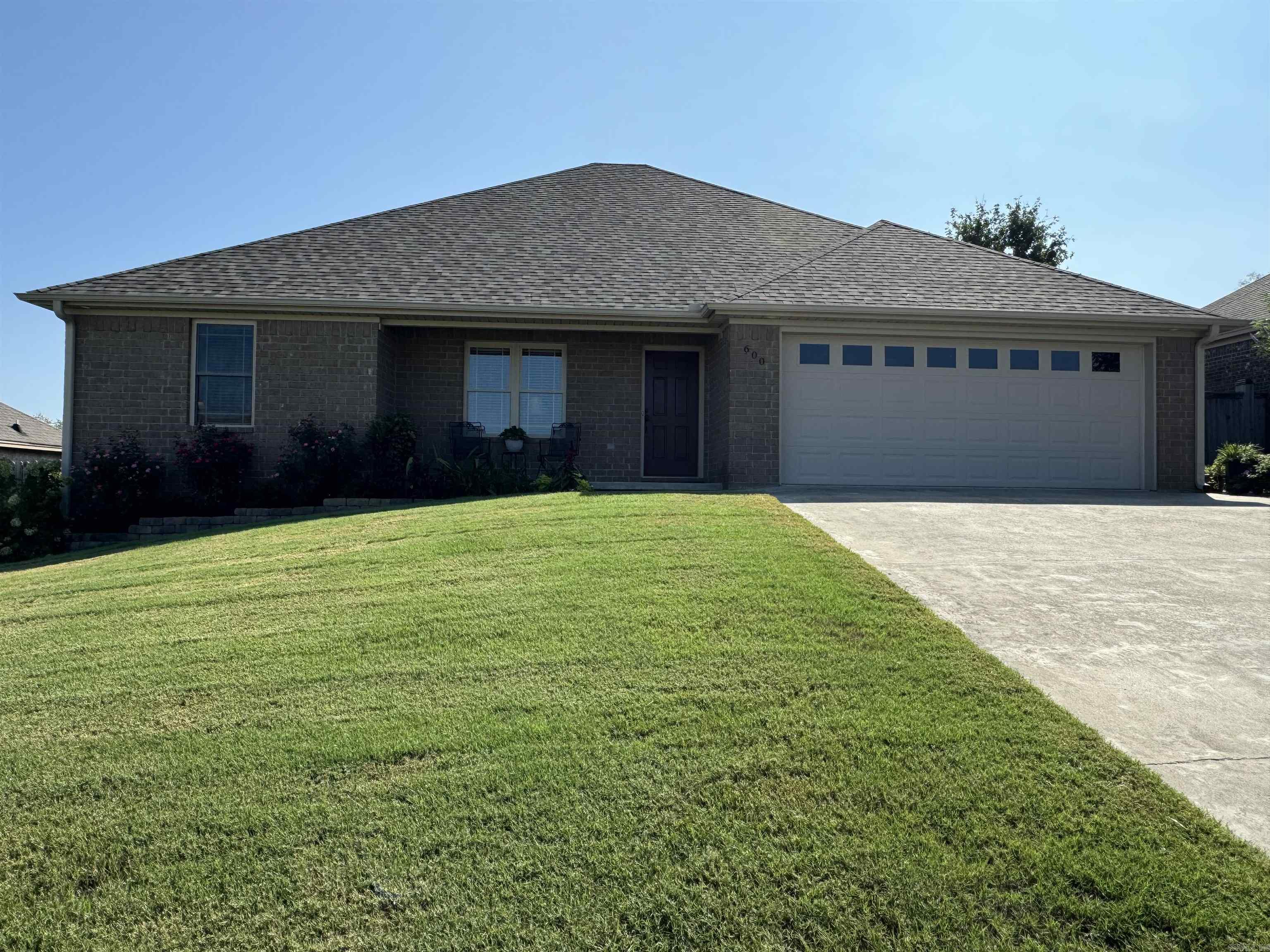 This custom home located in Ridgewood subdivision near Searcy Country Club is a true gem on the market. Boasting the title of the largest residence in the area, this custom-built home has been lovingly maintained by its original owner. A well-thought-out split floor plan offers a harmonious balance between shared spaces and private retreats. Recent upgrades include a brand-new HVAC system installed in October 2023 and fresh architectural shingles added in May 2024. With four bedrooms plus a versatile bonus room could be a home office, a crafting space, a sewing sanctuary, or a playroom for the little ones. Attention to detail is evident throughout the home, with six-inch exterior walls and additional insulation providing both durability and energy efficiency. The interior features exquisite wood porcelain tile that is not only durable but also enhances the home's overall aesthetic appeal. The heart of the home, the kitchen, showcases granite countertops, a spacious walk-in pantry, and the professional refrigerator, washer and dryer stay with the home. The covered patio and beautiful gardens create an no maintenance paradise with apples on the tree, berries and beautiful flowers.
