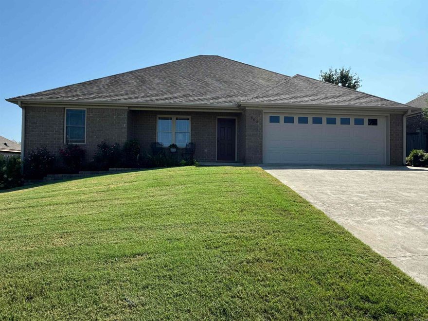 This custom home located in Ridgewood subdivision near Searcy Country Club is a true gem on the market. Boasting the title of the largest residence in the area, this custom-built home has been lovingly maintained by its original owner. A well-thought-out split floor plan offers a harmonious balance between shared spaces and private retreats. Recent upgrades include a brand-new HVAC system installed in October 2023 and fresh architectural shingles added in May 2024.  With four bedrooms plus a versatile bonus room could be a home office, a crafting space, a sewing sanctuary, or a playroom for the little ones. Attention to detail is evident throughout the home, with six-inch exterior walls and additional insulation providing both durability and energy efficiency. The interior features exquisite wood porcelain tile that is not only durable but also enhances the home's overall aesthetic appeal. The heart of the home, the kitchen, showcases granite countertops, a spacious walk-in pantry, and the professional refrigerator, washer and dryer stay with the home. The covered patio and beautiful gardens create an no maintenance paradise with apples on the tree, berries and beautiful flowers.