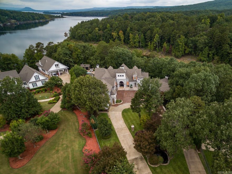 This beautiful lakefront home features a modern security system, theater, gym, sauna, wine cellar, pool, jacuzzi, outdoor kitchen, billiard room, three en-suite bedrooms, two guest wings, vaulted ceilings, Viking appliances, marble and granite countertops, and custom cabinetry.  A must see this beautiful place has it all inside and out!