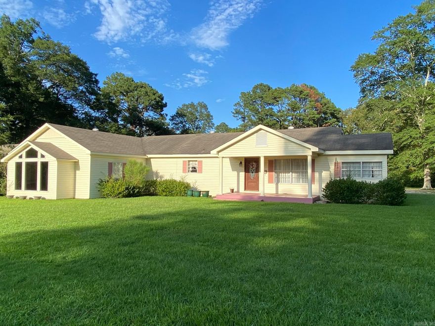 Spacious home sitting on 2 lots, close to town, large family room, kitchen with breakfast area, dining room, three bedroom, two bath, sunroom, large deck covered  (perfect for grilling and relaxing in the evening shade), two separate storage buildings Property has a beautiful back yard with room to grow.