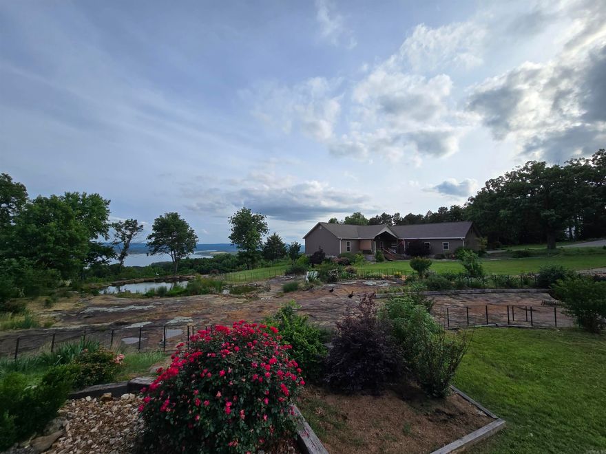 Here is your chance to own a very rare property with one of the very best lake views on Greers Ferry Lake.  This little description and few photos do it no justice.  If you're in the market for something like this, go look at everything else first, then come see this.  There is nothing better.  Situated on 5.19 fenced unrestricted acres with expansive views right through the Narrows bridge from every room of the 2492ft² 3 bedroom, 3 bath custom main home with with large open living area, cooks kitchen, large pantry, laundry/sewing room, over-sized 2 car garage with professional dog washing station, walkout master bedroom, large covered back deck, loads of smart storage, perfectly clean and move-in ready. if you need more space, there is also a 30'x100' shop with side entry and RV doors and a 1500ft² 2 bedroom, 1.5 bath guest house inside that also has one of the best lake views on this lake as well as overlooking the thriving koi pond built into an unbelievable rock formation.  Gated entry from Irish Hills and Edgemont roads.  This is the opportunity of a lifetime.  Call today to schedule your private showing this weekend.