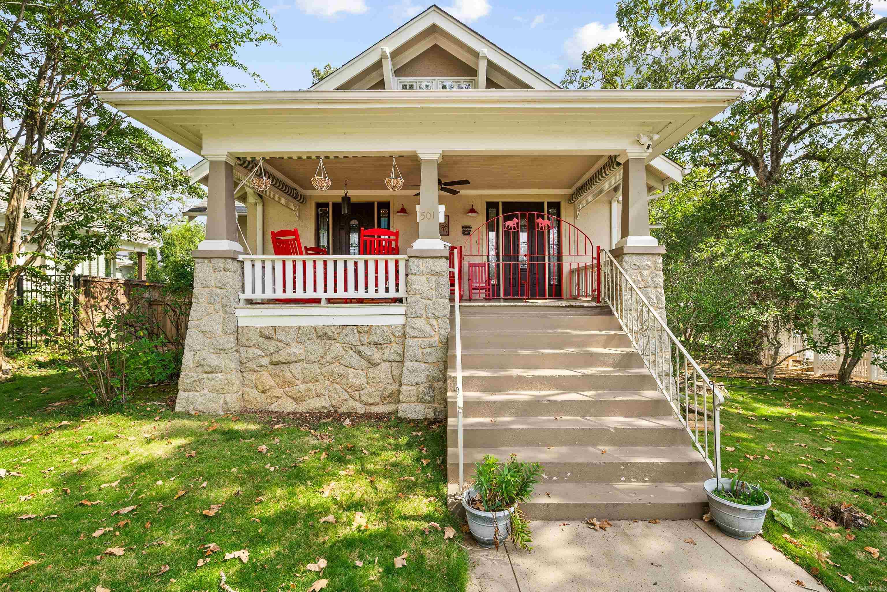 This truly special craftsman home in Hillcrest, listed on the Historic Registry, blends timeless architecture with modern updates. The main level was fully remodeled in 2024 with a custom kitchen, whimsical backsplash, matching dining cabinetry and all new appliances. 2 bedrooms sit on the main floor, while the spacious downstairs primary suite offers a massive walk-in closet, sitting area, office and walk-out to the backyard. Downstairs' reno in 2018 included 2 sump pumps, a tankless water heater, and updated systems to ensure comfort and efficiency. The attic is floored, partially finished, and heated/cooled—perfect for storage or future expansion. The guest cottage has new flooring and new AC. The corner lot and a half features towering oaks, crepe myrtles, and a charming rock wall fully fenced backyard that includes a storage shed and private access to the guest cottage and driveway that provides drive-through parking from the alley to Lee Street. From here, you’re just two blocks from Kroger and three blocks from Kavanaugh’s shops, restaurants, coffee spots, and cafés. It's not just a home, it's a lifestyle! Attic and cottage sq ft not included in listed sq ft.
