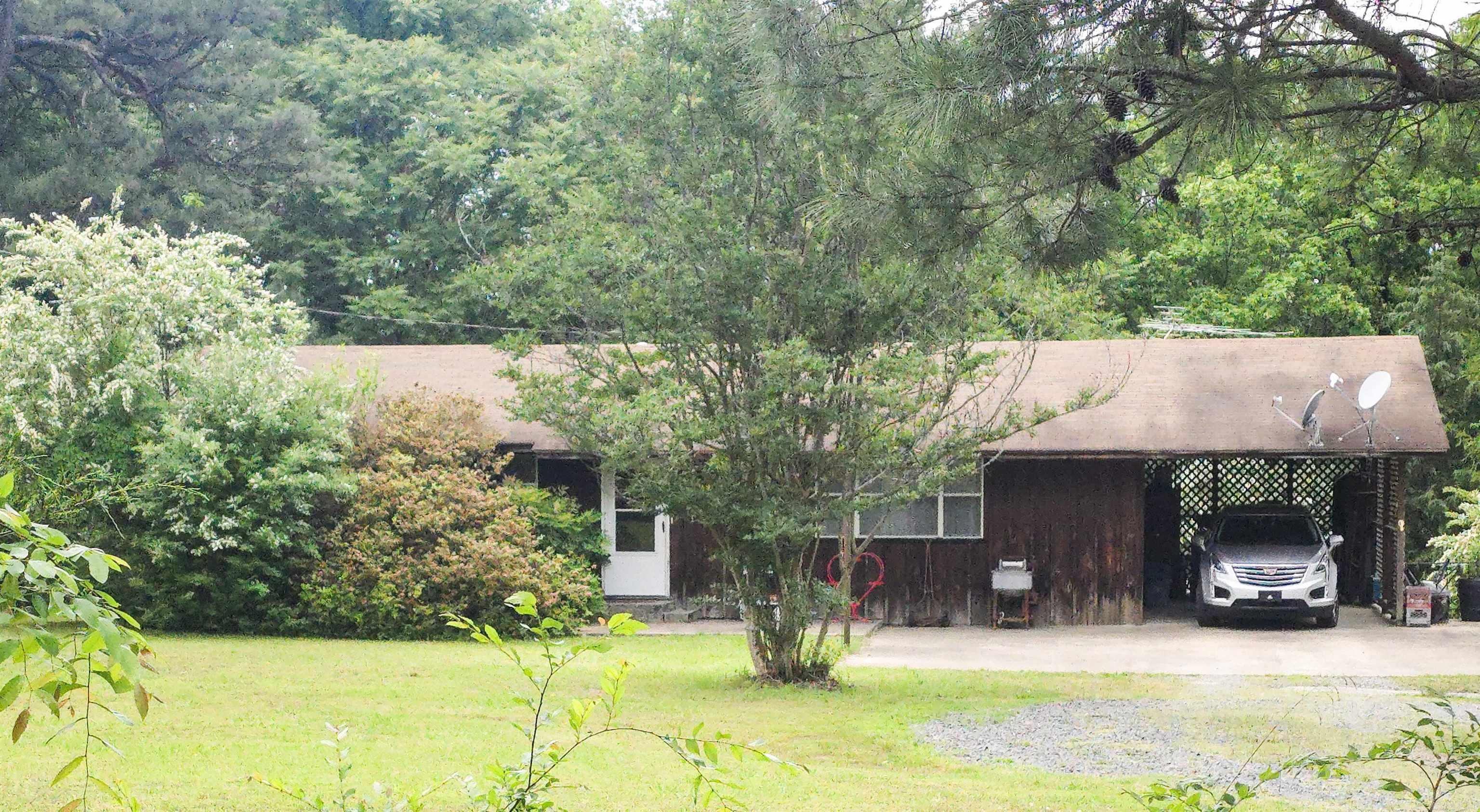 This wonderful property offers a UNIQUE OPPORTUNITY and it is just 10 minutes from Ferguson's Choctaw Marina on Greers Ferry Lake!! The detached building sits at the top of the property with Highway 65 frontage, and was operated as a thrift/antique store for decades!! You could re-open the doors to the public or get creative and make the space your own! The 3 bed, 2 bath home is nestled along the treeline on the back of the 1.18 acre property, with a beautiful front yard and serene back yard. Walking through the front door you are greeted by a large living area open to the eat-in kitchen with the bedrooms all down one hallway - ideal for gathering with friends and family. The covered back porch and fenced back yard are perfect to move the hangout outside, and enjoy room for kids or pets to run and play.