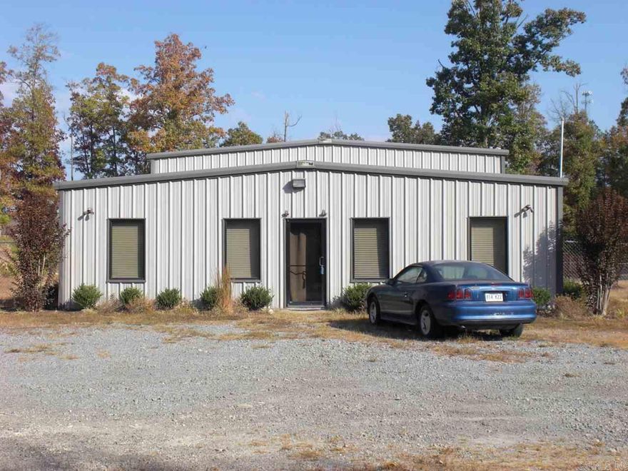 Office / Warehouse / Living Combo.... Amenities include: 1200 sf Living Quarters with 2 bedrooms, 2 bathrooms, full kitchen, office room, living room. 2400 sf warehouse with 3 - 14' wide x 14' tall overhead doors, storm/safe room, bathroom, overhead storage, partially fenced with tall Chain link fencing, 5.03 acres +/-, and much more...... This building would make a great office and warehouse for Plumber, Electrician, Htg. & Air, Auto, and any Construction Services, or have shop and build house on property.
