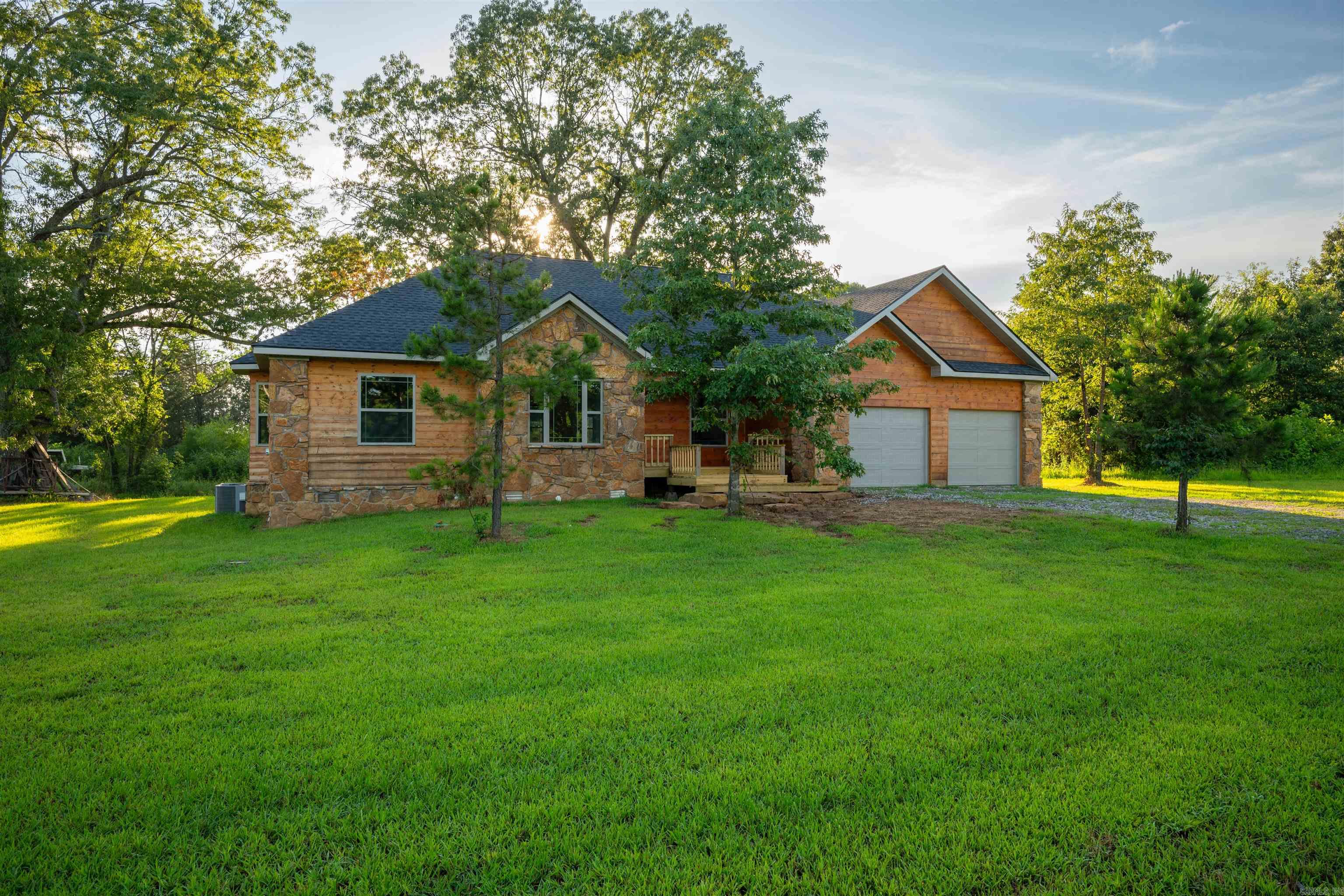 Tucked away on a peaceful, low-traffic road, this beautifully finished home blends rustic charm with modern luxury. From the moment you pull up, youāll be wowed by the stone and wood exterior, surrounded by mature trees and lush green space. Step inside to a light-filled, open-concept layout featuring soaring vaulted ceilings, luxury vinyl plank flooring, and designer fixtures. The spacious living room flows seamlessly into a stunning kitchen complete with granite countertops, custom cabinetry, and a breakfast bar perfect for entertaining. Enjoy your morning coffee in the cozy breakfast nook with wraparound windows or peaceful views from the large back deck. The split floor plan offers privacy and comfort, with the primary suite tucked away for quiet relaxation. This one checks every boxāmodern finishes, tranquil setting, and space to stretch out and breathe.