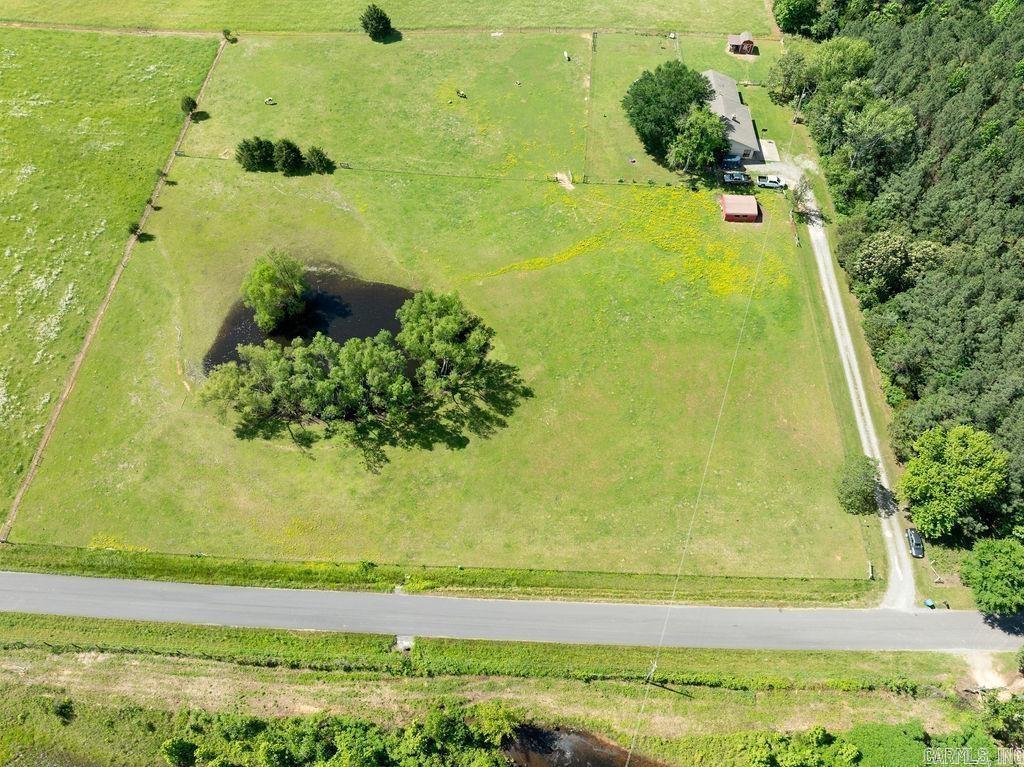 This gorgeous country home is loaded with quality craftsmanship and design with plenty of nostalgic character and charm. The mini-farm property encompasses 5 beautiful acres of lush pasture and has a clear water pond for recreation, livestock, and wildlife. The house and acreage is surrounded by leased farmland providing the owner a great sense of privacy and freedom within a pristine and scenic landscape.