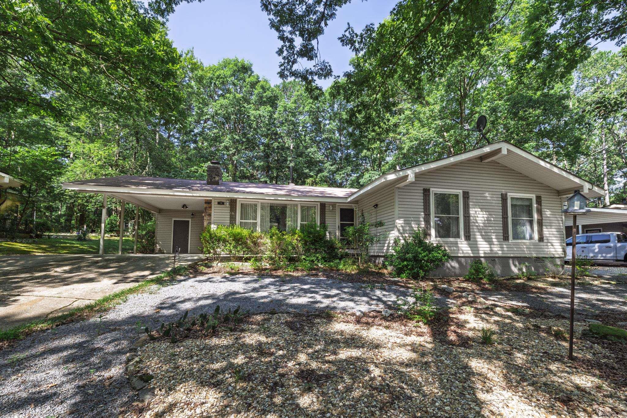 Don't miss this one! Large living room with picture window and gas fireplace opens to spacious dining room. The modern kitchen boasts quartz counters, upgraded cabinetry, vinyl tile flooring, gas cook stove and newer appliances. This home has newer windows, HWH in 23, LVP flooring, newer light fixtures, sinks and faucets, no popcorn, and excellent storage. The newer heat is propane and there is a 500 gal buried tank. The primary suite has a large walk in closet, no entry shower, bidet and large dressing area. Off the dining room you will enjoy a four season Arkansas room for hobbies or just enjoying the relaxing scenery. There is also a surprisingly large storage area/workshop off the AR room. The property is fenced and ready for your enjoyment. Exterior is no maint vinyl. Hot Springs Village is a 26,000-acre gated community with 11 lakes, 9 golf courses, white sand beach, hiking trails, pickle ball, fitness center, indoor and outdoor pool, tennis and SO MUCH MORE. One time POA buy-in fee $2000 due at closing. Come to the Village and enjoy the life you deserve.
