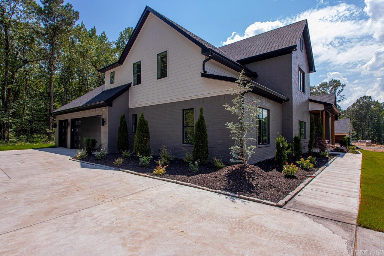 Discover this stunning custom home nestled within the peaceful Bryant school district, offering unparalleled privacy in an exclusive, neighborhood set on a one-acre wooded lot. This home features an exceptional floor plan designed to accommodate all your needs, highlighted by an expansive oversized kitchen boasting a massive pantry and abundant cabinet space. The luxurious Primary Suite includes a walk-around shower, large soaking tub, and a large custom closet. Throughout the home, you'll find numerous modern upgrades and finishes. Step outside to enjoy the secluded backyard and expansive covered patio complete with a cozy fireplace, perfect for relaxation and entertaining alike. Come see!