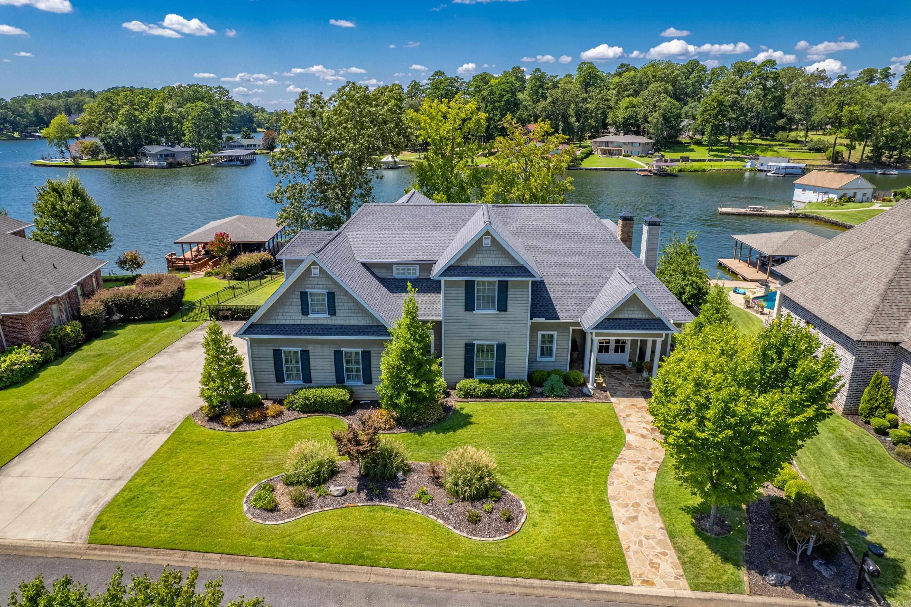 Stunning Lakefront Home on Lake Hamilton! Welcome to this exceptional 4-bedroom, 5.5-bathroom lakefront retreat located in one of Lake Hamiltonās most prestigious neighborhoods. Boasting 130 feet of prime lake frontage, this luxurious residence offers the perfect blend of elegant design, comfort & unmatched views. Step inside to an open-concept main level designed for both everyday living and effortless entertaining. The chefās kitchen is a culinary dream featuring a gorgeous island, upscale appliances, a gas cooktop, double ovens, and ample storage. The main floor includes a home office, which could be used as a 5th bedroom. Two spacious bedroomsāone being the large primary suite with a ensuite bathroom that defines luxury and provides beautiful lake views. Upstairs, a second living area awaits with a wall of windows framing breathtaking views and built-in wet bar. You will have more than enough room for everyone with a huge quad bunk room perfect for kids, plus two generously sized guest bedrooms. Continued in Agent remarks...