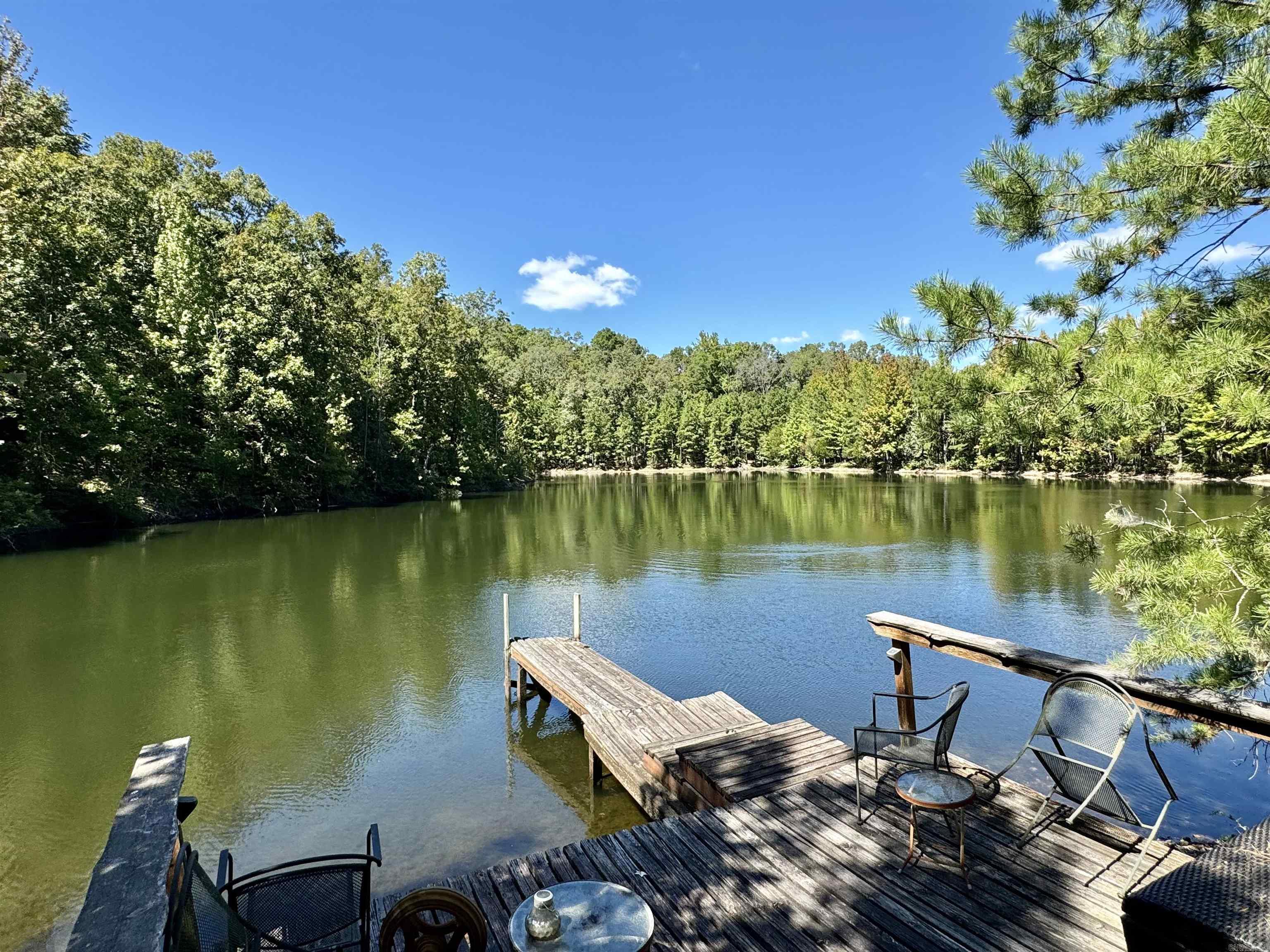 191 ACRES with a cabin, shop, barn, & a 2.5 acre lake in the Ozark Mountains!! This property consists of a mixture of woods for hunting & exploring and an open area that is fenced for horses or livestock! The Main Cabin is 1 bedroom, 1 bathroom featuring beautiful hardwood flooring throughout & a large front porch to enjoy the view! The property is well equipped with outbuildings, a 40x60 shop, and a barn. In addition there is an old cabin on the property with a well and electric already in place. There is a seasonal creek that runs on the property. There are multiple building sites for another cabin or home, but one spot in particular with some clearing, could have a fantastic view of the OZARKS! Although this property is quiet and secluded it is located on Scenic Hwy 9 for easy access into Mountain View & Melbourne. Less acreage can be purchased. Call for details.