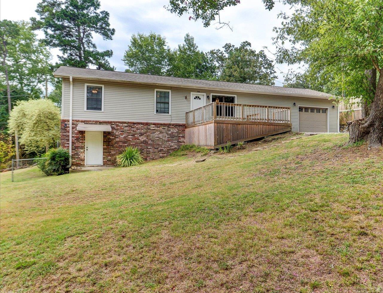 186 Vanadium ā Multi-Family Home Near Lake Catherine Spacious 6-bedroom, 3-bath multi-family home with seasonal lake views on a private 1.22-acre lot! The upper level offers 4 bedrooms, 2 baths, an open living/dining/kitchen layout, multiple decks, and a 2-car garage. The lower level includes a separate entrance, living room, eat-in kitchen, 2 bedrooms, office, and full bathāideal for guests, in-laws, or rental income. The property features 2 gated entrances, mature trees, and room to build a second lake-view home with its own driveway. Just steps from Lake Catherine and boat launch access, this home combines country charm with lake living convenience.