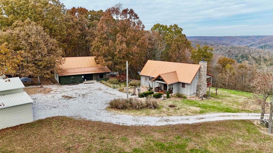 Spacious Home & Guest House with Breathtaking Ozark Mountain Views! The main home welcomes you with an open floor plan, vaulted wood ceilings, and a spacious kitchen that flows into the dining area surrounded by oversized windows. The main-floor master suite includes a full bath and walk-in closet. Downstairs, the walk-out basement offers two additional bedrooms, a full bath, a large shared walk-in closet, utility room, and a safe room. The guest house, currently operating as a nightly rental, is designed for comfort and entertainment with a generous bedroom, expansive living area, full kitchen, full bath, and a second bedroom or office. Above the guest house is a large storage room! Outdoor living is a highlight, featuring a screened-in porch, large deck, and private firepit area. The guest house comes furnished minus a few items! Additional features include a 42x24 carport/barn with fenced in area, tons of landscaping, whole house generator, new roof, new HVAC system, & more! Located near the White River, National Forest, & Downtown Mountain View!