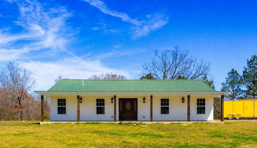 Set on approximately 3± acres along paved Sugarloaf Road, this modern farmhouse-style home offers the perfect blend of newer construction, spacious living, and a convenient location. Built in 2023, the home features approximately 2,000± sq ft of heated and cooled living space with 3 bedrooms, 2 bathrooms, and a bright open-concept living and dining area highlighted by vaulted ceilings and an inviting layout designed for both everyday living and entertaining.  The interior showcases stylish finishes throughout, including custom cabinetry, beautiful flooring, updated fixtures, and a custom walk-in shower in the primary suite. The expansive covered front porch—approximately 500± sq ft—creates the perfect place to relax and enjoy the relaxing setting and large level yard.  Additional features include city water through Kimzey Water, septic system, South Central electric service, and a brand new roof already in place. Conveniently located approximately 20–25 minutes from Hot Springs and around 10 minutes to both Glenwood and Amity, this property offers the feel of country living while remaining close to nearby conveniences.