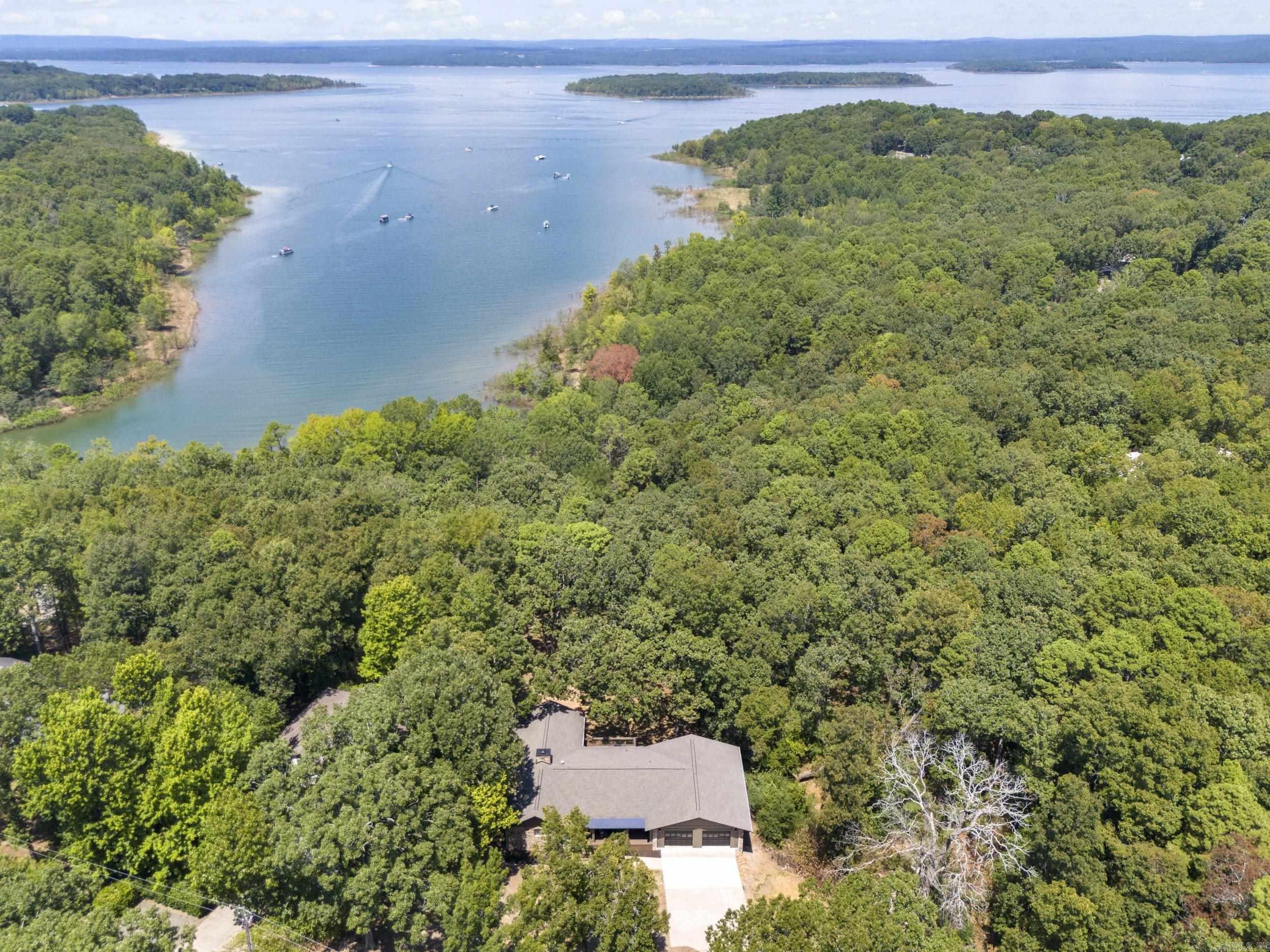Incredible Greers Ferry Lakefront home remodeled by Hurd Custom Homes. The attention to detail speaks to the quality of workmanship and thought that went into bringing this 1987 home up to meet the needs of modern living in 2025. Open concept living space on the main level of the home speaks to easy living and entertaining. Native stone fireplace, vaulted ceiling, and wall of glass leading to a large covered deck overlooking the backyard firepit and lake. Walkout basement level boasting a Den, a bonus room, and 3 Bedrooms. The master suite is located on the main level.Plenty of room for family & friends in this 3836 SF lake home. 31 x 36.9 dream garage for all your lake toys. SEE ASSOCIATED DOCUMENTS for larger floor plan and detailed information