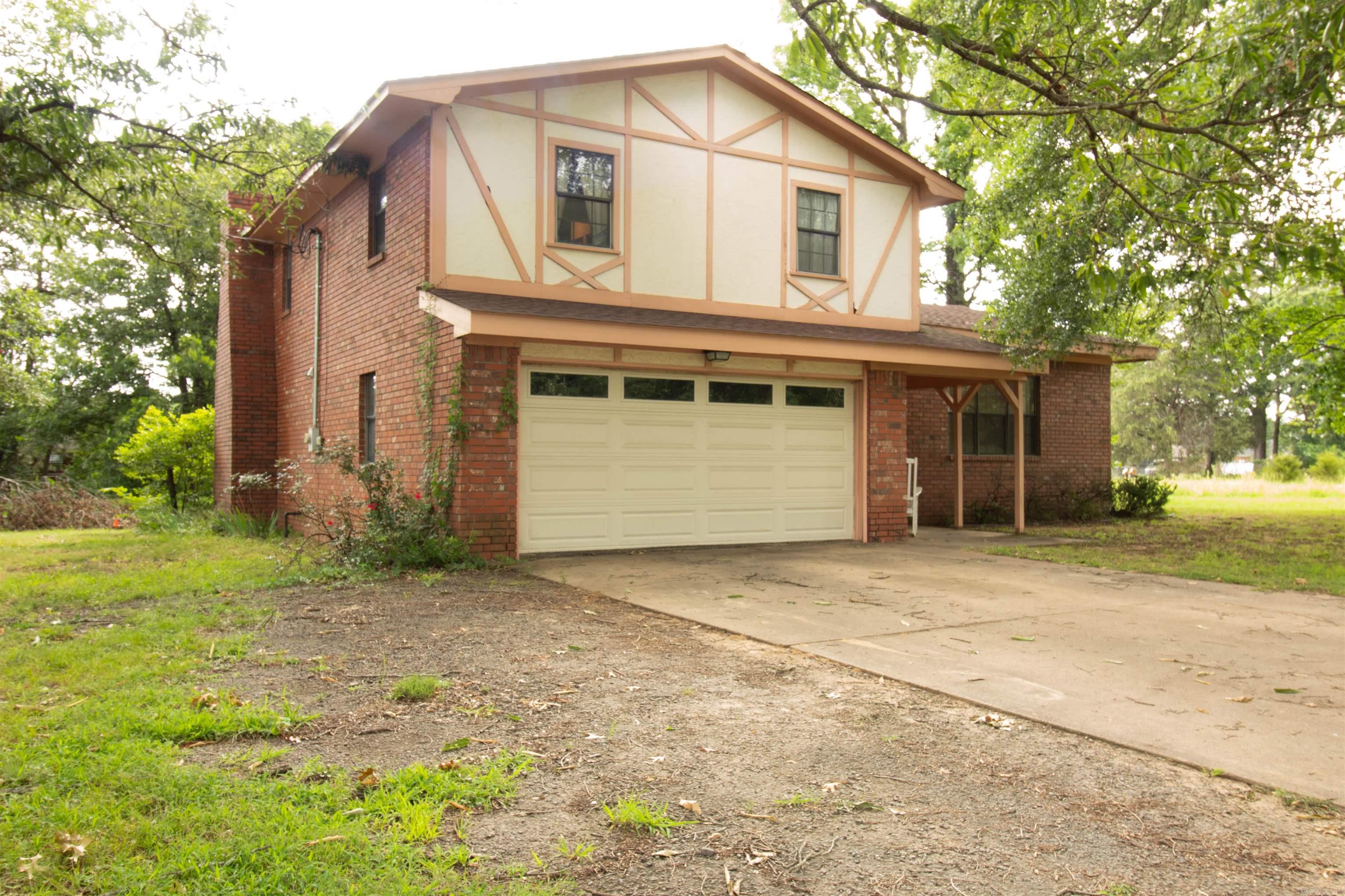 Discover the perfect blend of comfort and charm in this exceptional 3-bedroom, 2.5-bathroom home located in the city limits of Clarksville, Arkansas. Nestled on a desirable 1.22-acre lot adorned with many shade trees and few neighboring houses, this property offers a tranquil retreat while still being conveniently close to local amenities. Step inside to find a beautifully designed interior showcasing built-ins that add character and functionality throughout the home. The spacious living area is perfect for entertaining and features a mini bar, ideal for hosting friends and family gatherings. The home is being sold fully furnished, including everything from the refrigerator to stylish couches and cozy beds, making it truly move-in ready! The three well-appointed bedrooms provide ample space for relaxation, while the 2.5 bathrooms ensure convenience for all. Enjoy the serenity of your expansive outdoor space, perfect for gardening, recreational activities, or simply soaking up the peaceful surroundings under the shade of the trees. This unique home is a rare find in Clarksville, offering both privacy and accessibility. Don’t miss your chance to own this furnished gem!