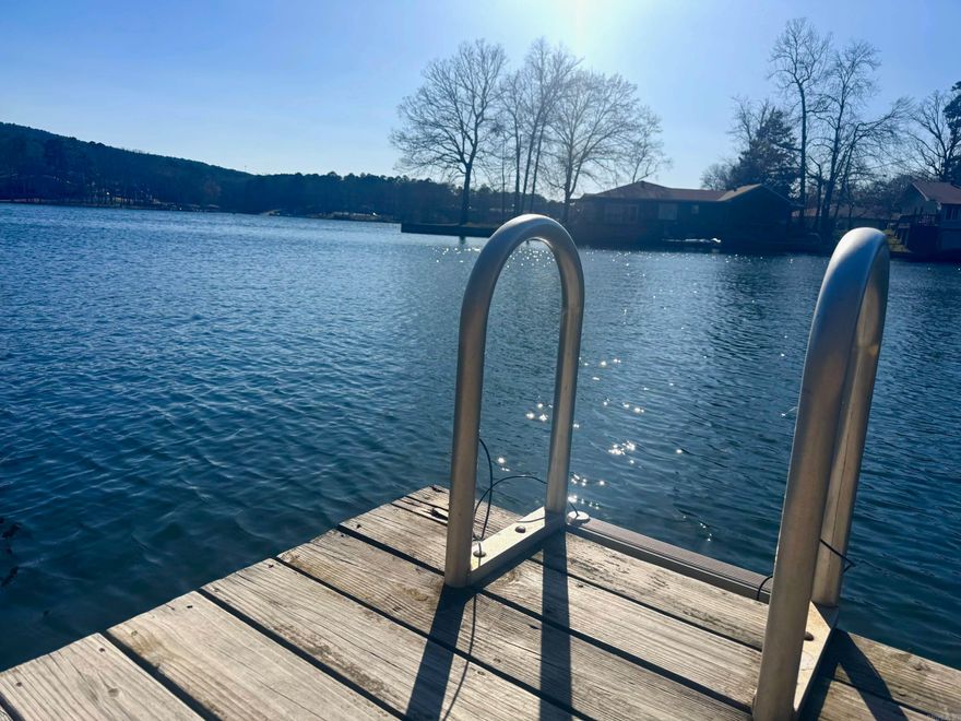 Steps to Lake off back porch with your own private boat dock! Sept 2025 NEW ROOF! 2023 updates: new paint, new shower/bath, new LVP flooring throughout main living and bedrooms. Enjoy lake life with an upper and lower deck option!  Both bedrooms on bottom floor, one with walkout to Lake DeSoto. Lake stays high ALL year long! Kayak, swim and hike by walking out, enjoy 9 golf courses and 11 lakes of HSV, 30 minutes from Oaklawn and downtown Hot Springs.  2nd home, investment airbnb, or primary, you choose!