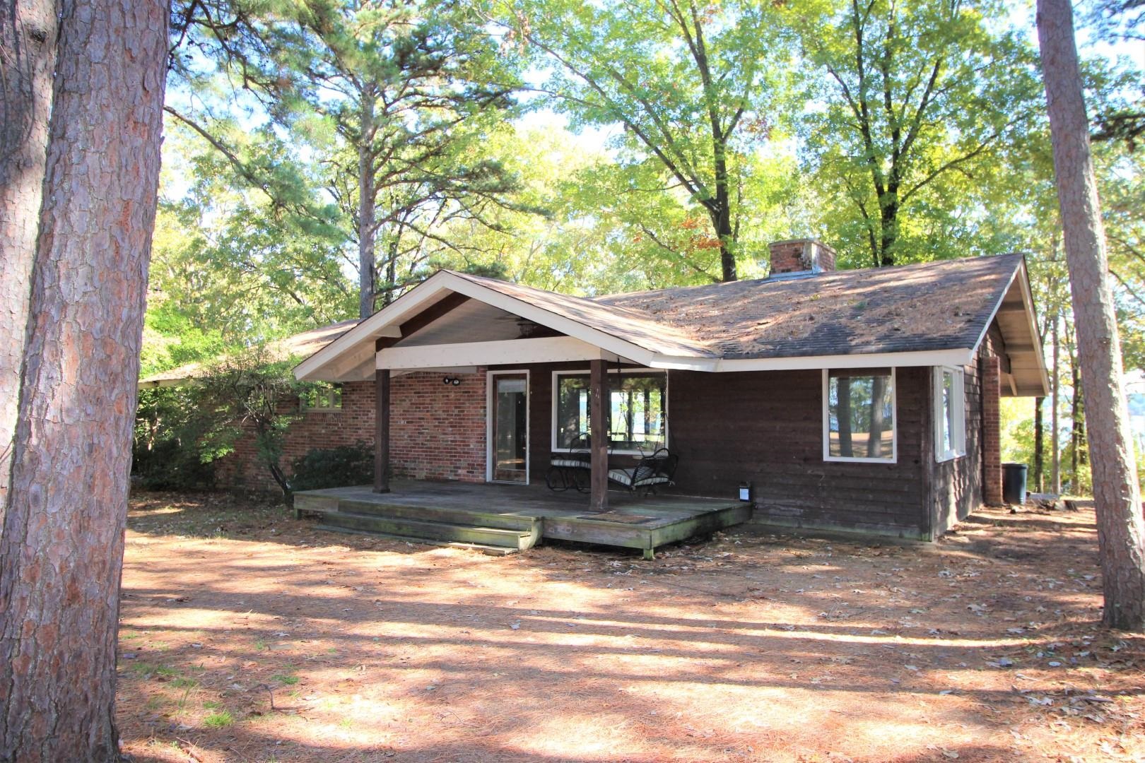 Eden Isle LAKEFRONT HOME!!!  3-bedrooms, 2-baths, open floorplan with tall ceilings, nice windows, stone fireplace, slate floors, great covered back deck, circle driveway and TONS of Eden Isle Charm!  This home already has the right look, it just needs a little scrubbin'!!!  There's not a better location on the island!