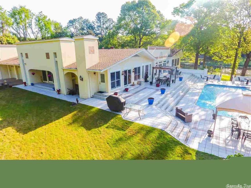 THIS BEAUTIFUL OASIS..MEDITERRANEAN STYLE HOME..TUCKED AWAY..HAS IT ALL!! THE LAKE(430 SQ FT LAKE FRONTAGE)!THE POOL!THE VIEW!! IT'S FASCINATING! IT'S GATED! IT'S LOADED W/ HAND CARVED MOLDING, GRANITE COUNTER TOPS, GRANITE FLOORING, WALNUT BUILT-INS,+INSULATED WALLS!  HAS A SUNROOM, BONUS ROOM,IN-LAW QUARTERS DOWN(counts as a 4th bedroom) WORKSHOP,  SEPARATE POOL HOUSE/CARETAKERS/IN LAW QUARTERS! ITS LIKE HAVING A COUNTRY ESTATE BUT CLOSE TO CIVILIZATION!