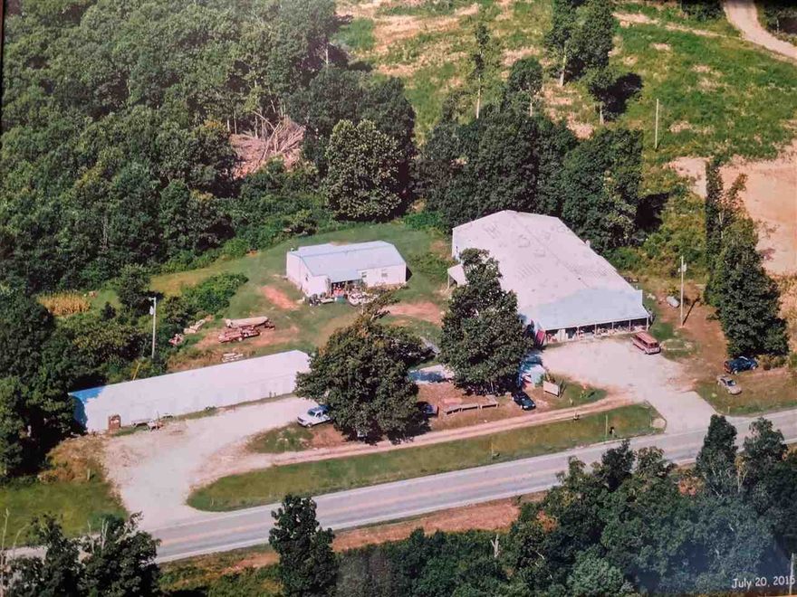 Commercial Buildings AND Residential Home. Flexible live-work-invest INCOME POTENTIAL! Prime mixed-use property. Home: 1288 sqft, 2 bedrooms, 1.5 baths, metal roof, back porch with view - Ideal for on-site living, rental income, or office conversion. Commercial Buildings: 6168 sqft, main 100'x54' structure with 6'x48' addition for expanded operations, storage, and suitable for retail, service business, workshop, event venue, or multi-use commercial purposes.  Storage unit facility: 2000 sqft, 4 units at 10'x20' each and 3 double units. Key Advantages: High demand due to strong tourist-driven traffic in the Spring River area and local housing needs, high-visibility highway frontage. Possible campground attraction. Outdoor attractions include hiking, fishing, canoeing, kayaking, nearby lakes, and Ozark mountain views. Priced to sell, as it needs some "fixing up". See separate listing for more information on the included residential home. (some wide angle photography used)