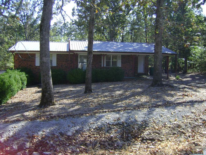 AFFORDABLE BRICK 2 bedroom home, one bath is now on the market at a very reasonable price. The house has central air and a one car carport with extra storage, metal roof and you have a low maintenance yard with pea gravel to save time on mowing.  It has a gas log fireplace that is used to heat the house.  It has a electric stove and refrigerator that is also included.  You can enjoy the outdoors with a screened in covered deck.  This house is priced to sell, so come see it today.  Call before it is sold.