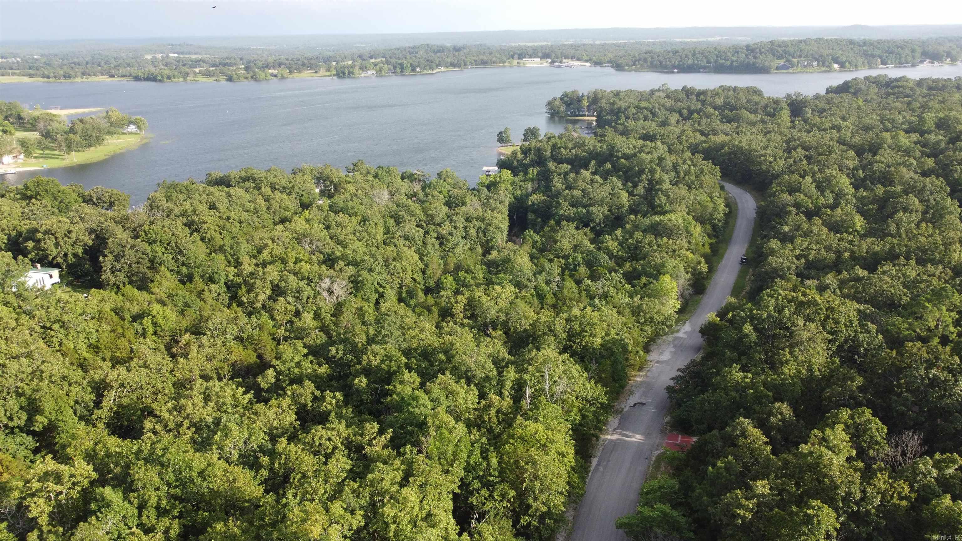 Wooded Lot in Emerald Cove ā Horseshoe Bend, AR Discover the perfect setting for your forever home or vacation retreat in the serene Emerald Cove subdivision, located within the city limits of Horseshoe Bend, Arkansas. This wooded lot offers a peaceful escape with paved road frontage, providing easy year-round access. Just minutes from beautiful Crown Lake, youāll enjoy endless opportunities for boating, fishing, and watersports. For nature lovers and adventurers, the scenic Strawberry River is also nearbyāideal for canoeing, kayaking, and casting a line. Despite the quiet, natural surroundings, youāre only a short drive from the heart of town, where youāll find local shops, essential services, and charming eateries. Experience the best of both convenience and tranquility in the breathtaking Ozarks. Donāt miss this chance to own a piece of paradise in the Ozarks!!!