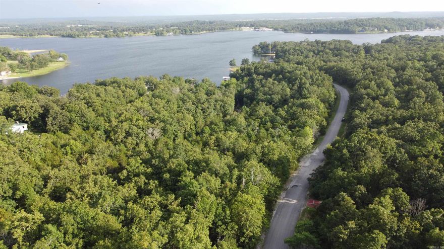 Wooded Lot in Emerald Cove – Horseshoe Bend, AR  Discover the perfect setting for your forever home or vacation retreat in the serene Emerald Cove subdivision, located within the city limits of Horseshoe Bend, Arkansas. This wooded lot offers a peaceful escape with paved road frontage, providing easy year-round access.  Just minutes from beautiful Crown Lake, you’ll enjoy endless opportunities for boating, fishing, and watersports. For nature lovers and adventurers, the scenic Strawberry River is also nearby—ideal for canoeing, kayaking, and casting a line.  Despite the quiet, natural surroundings, you’re only a short drive from the heart of town, where you’ll find local shops, essential services, and charming eateries. Experience the best of both convenience and tranquility in the breathtaking Ozarks.  Don’t miss this chance to own a piece of paradise in the Ozarks!!!