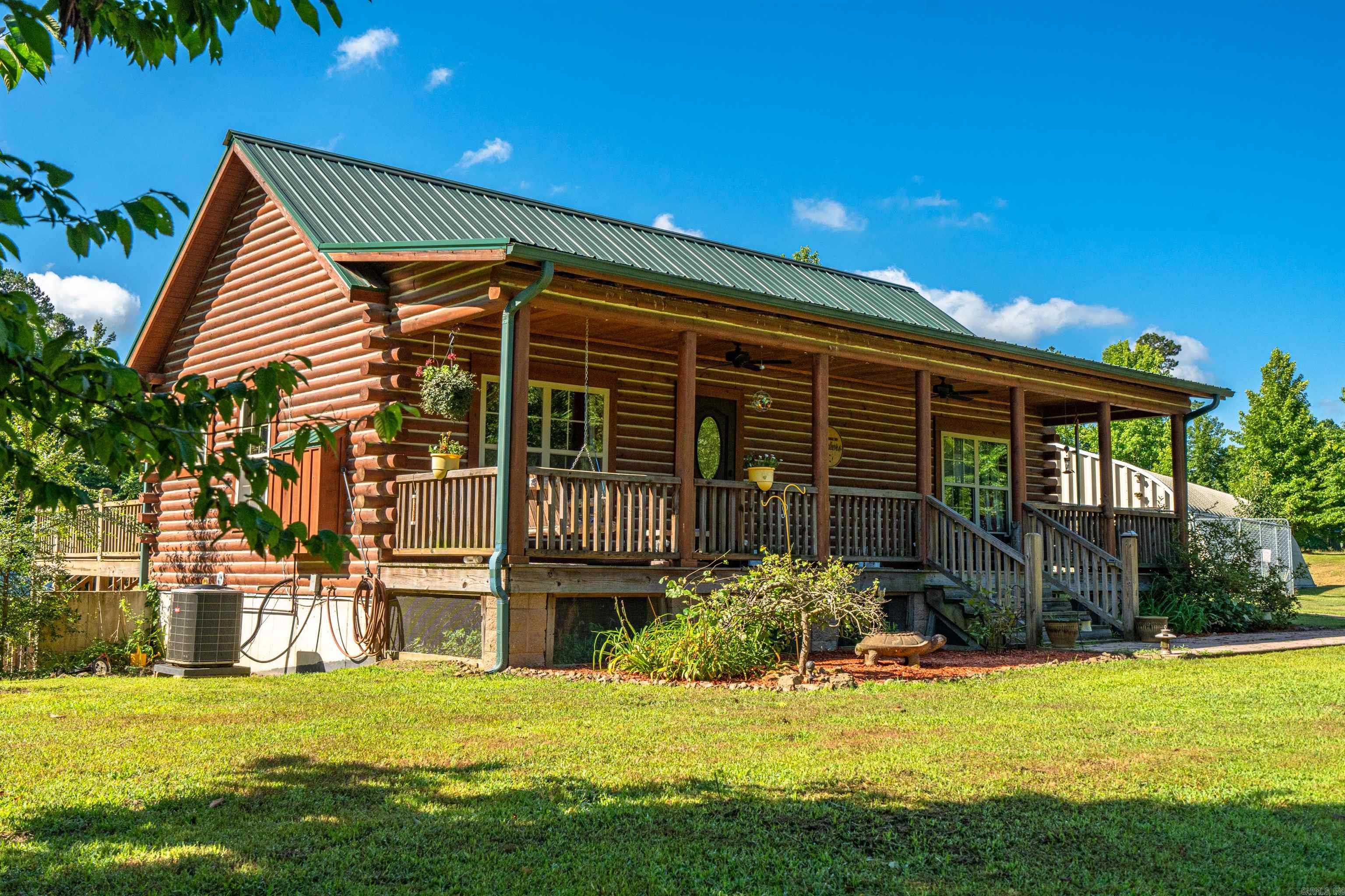 Rare find in Kirby, Arkansas. 6 acres with a cabin just minutes from popular Lake Greeson. With the areas growing demand for vacation rentals and recreational properties, this is an excellent opportunity for personal use, income potential, or long term investment. The seller spared no expense to create a cozy atmosphere with plenty of room for a large group. Featuring bamboo flooring, whole house water filtration system and humidifier, granite countertops and sink, wet bar, outdoor kitchen, 35x65 shop, huge finished basement and several fruit trees. This property also borders Corp of Engineers land. Less than an hour to Hot Springs National Park and less than 30 minutes to Albert Pike Recreational Area. New HVAC just installed.